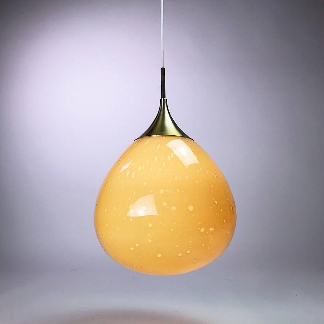 Amazing and classic Doria Leuchten Germany ceiling light from 1960s. 

Doria Leuchten is world known for it’s beautiful handcrafted glass pendants. 

This rare teardrop honey colored is made with two layers of glass to give it the bubble effect.