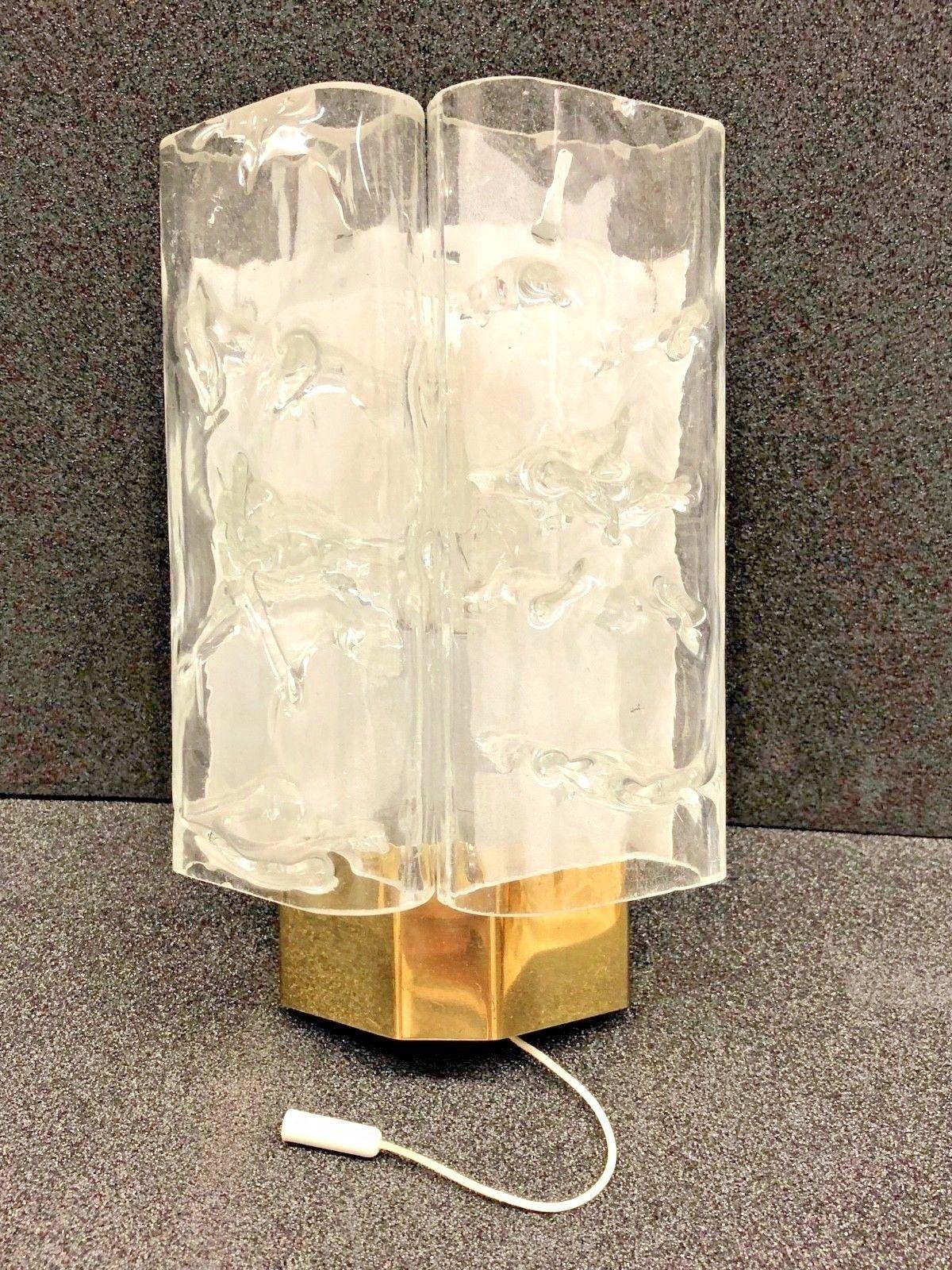 Elegant German Mid-Century Modern wall light with two clear textured glass tubes with brass base and mounted on white lacquered metal. Manufactured by German Doria Leuchten in the 1960s. Original pull switch that works perfectly. This fixture
