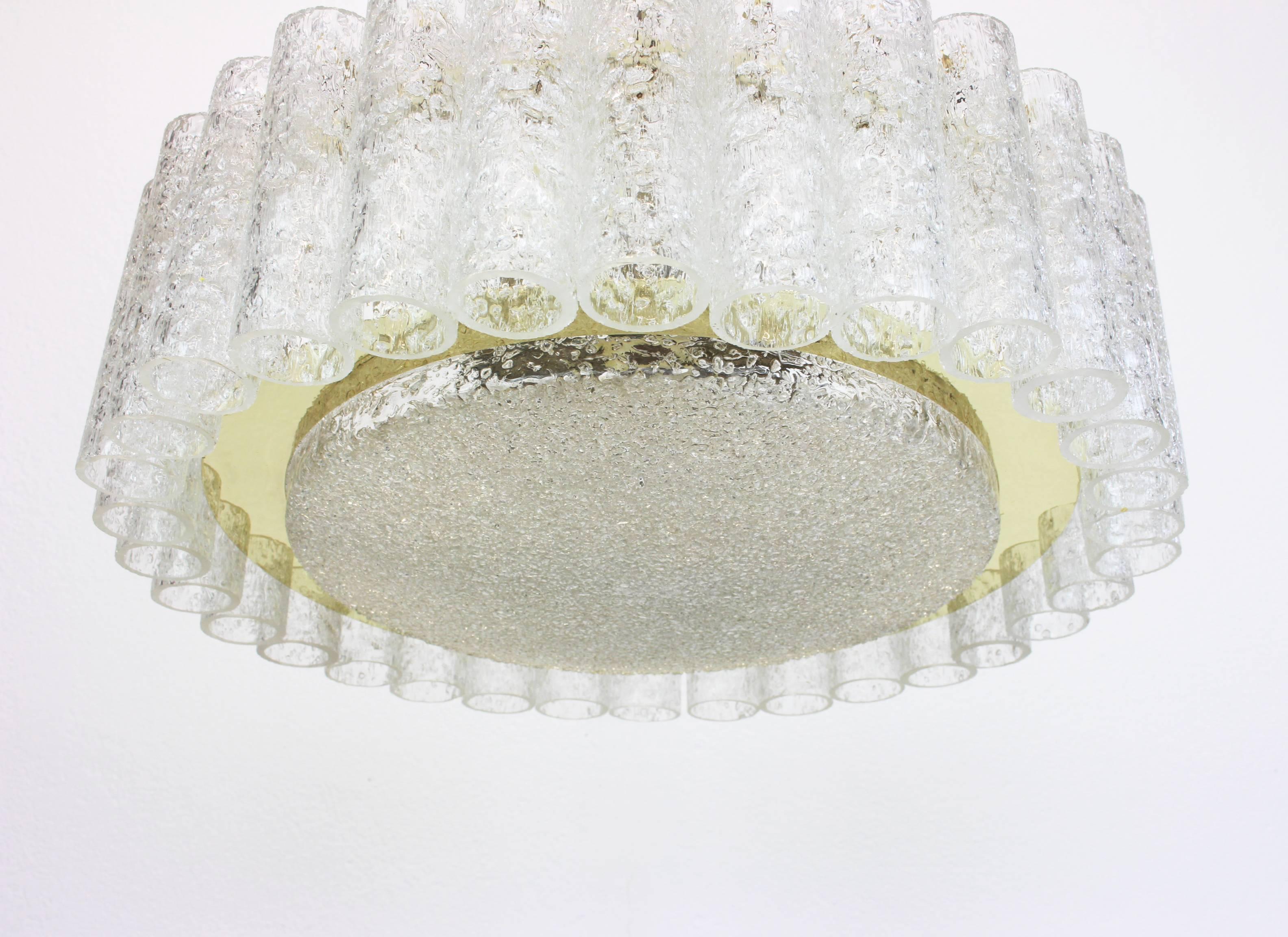 Beautiful chandelier with Murano glass tubes brass surrounding a brass ring, by Doria, Germany, manufactured, circa 1960-1969.

Sockets: Six x E27 standard bulbs.
Light bulbs are not included. It is possible to install this fixture in all