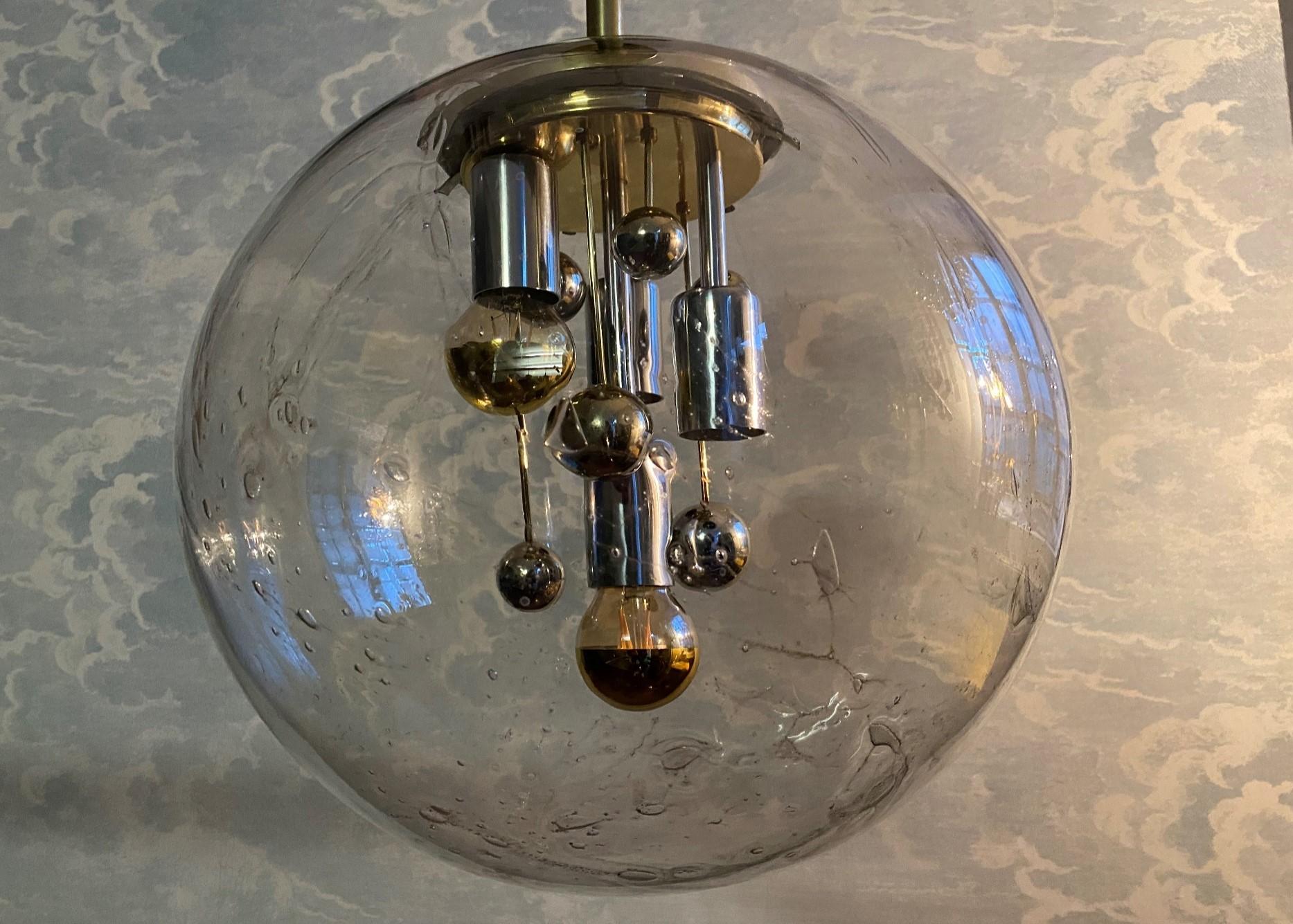 This amazing XL globe lamp with a diameter of 40cm (15.8 in) was made in Germany by Doria in the early 70s and has  Space Age written all of it. This rare edition comes with brass frame!

Made from vulcanized handblown glass containing many bubbles