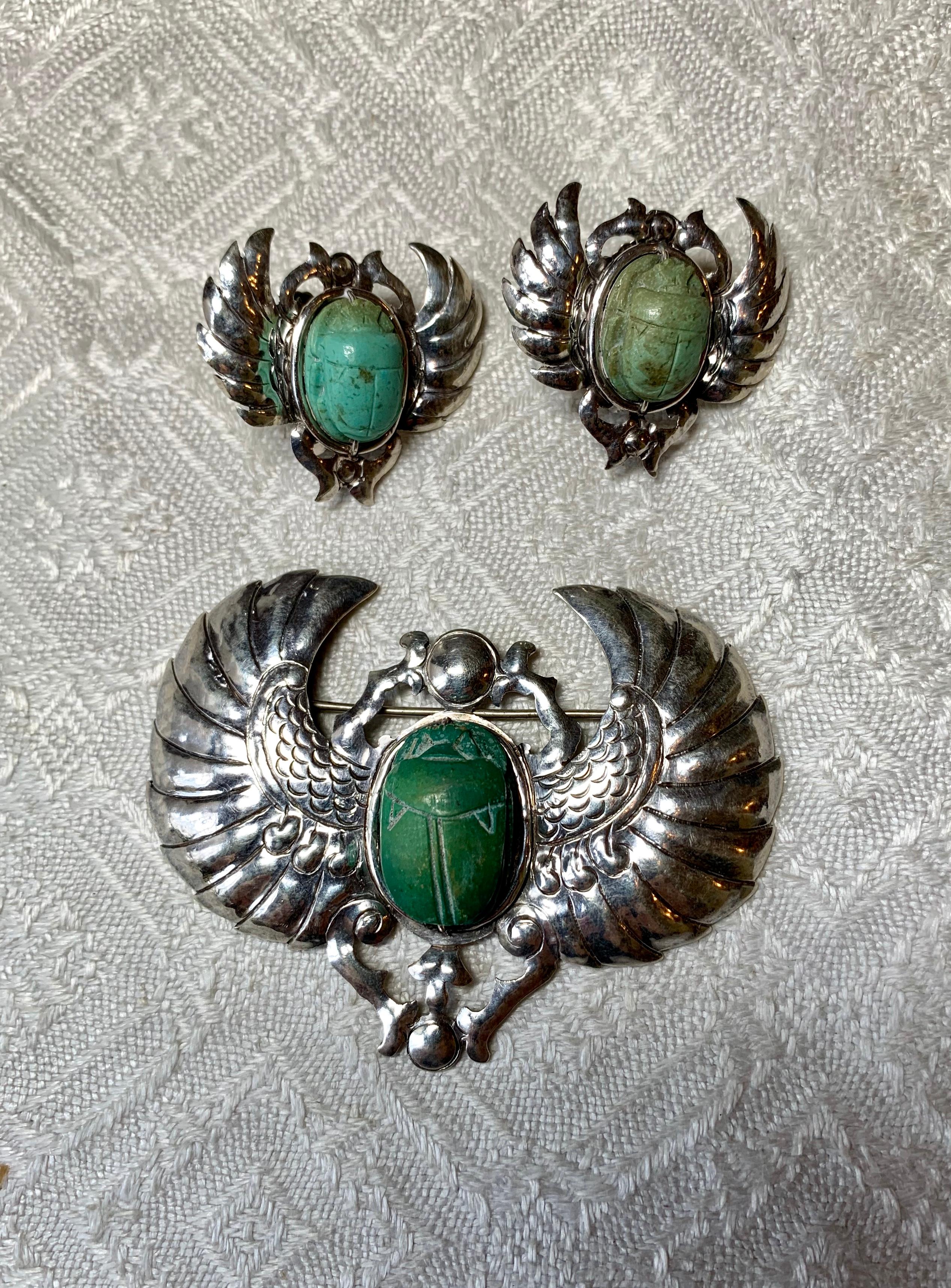 This is a very rare Museum Quality Parure of Scarab Earrings and Brooch.  The jewels are Egyptian Revival masterpieces by the acclaimed artist Doris Cliff (1885-1968) of Chicago.   The earrings and brooch are hand wrought in Sterling Silver with