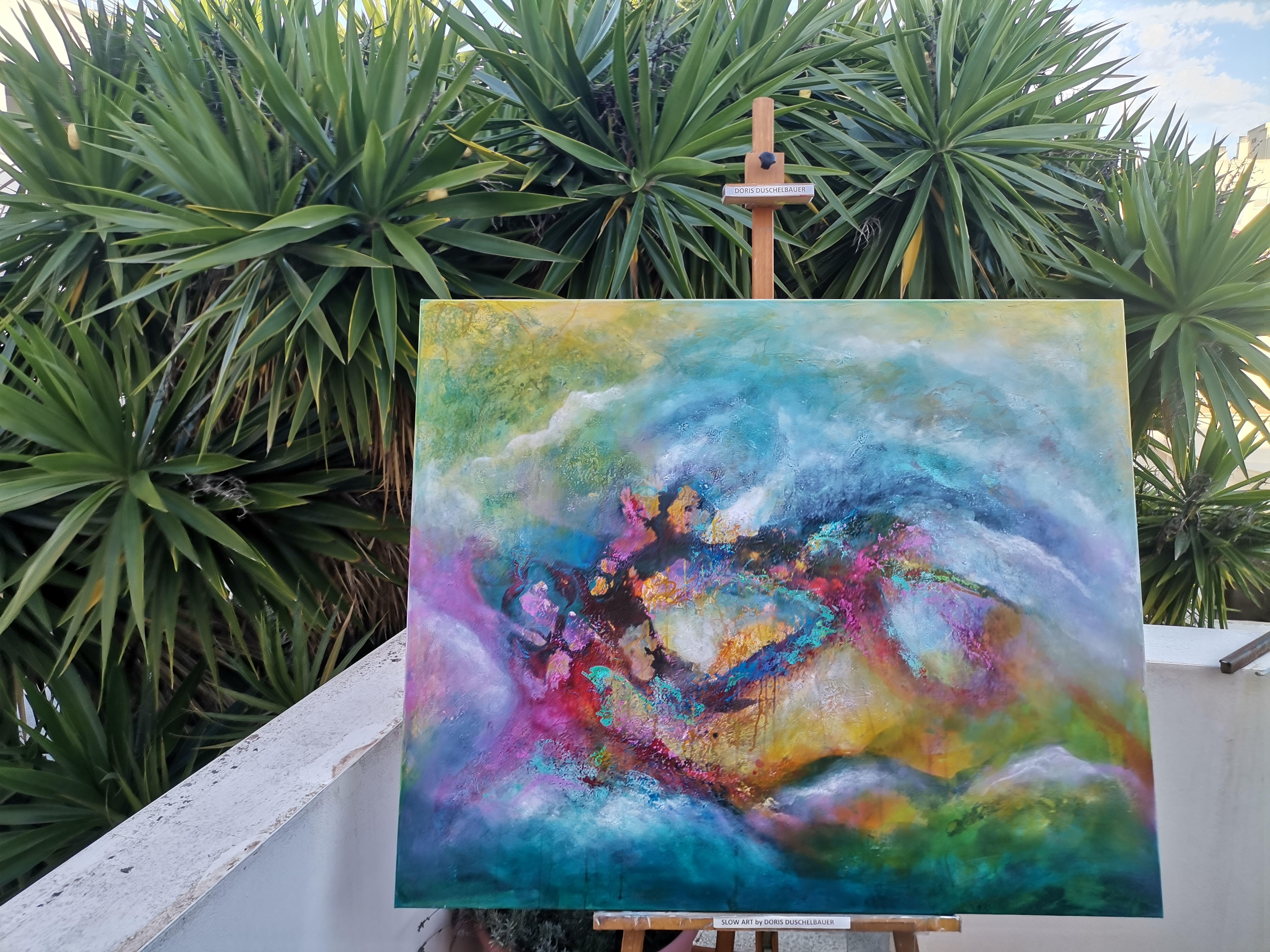 This energetic painting sparkles with energy and shows the beauty of colors and imagination. The painting consists of multiple layers of paint, mainly strong and vibrant colors like yellow, pink, green and blue, applied with a spatula on the canvas.