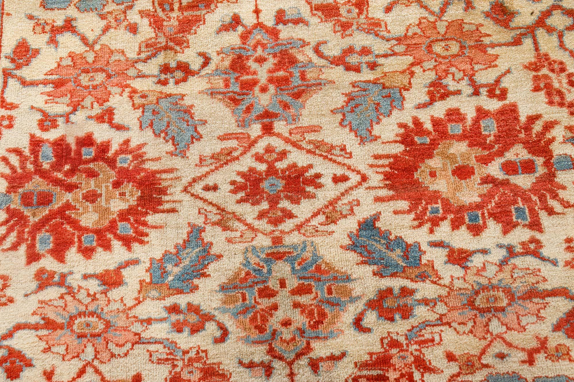 1900s Persian Sultanabad beige, blue, brown, pink and red handwoven wool rug 
(Size adjusted).
The main field of this Sultanabad rug, made circa 1900, is occupied by an allover botanical grid with palmettes, herati, and flower motifs. This design is