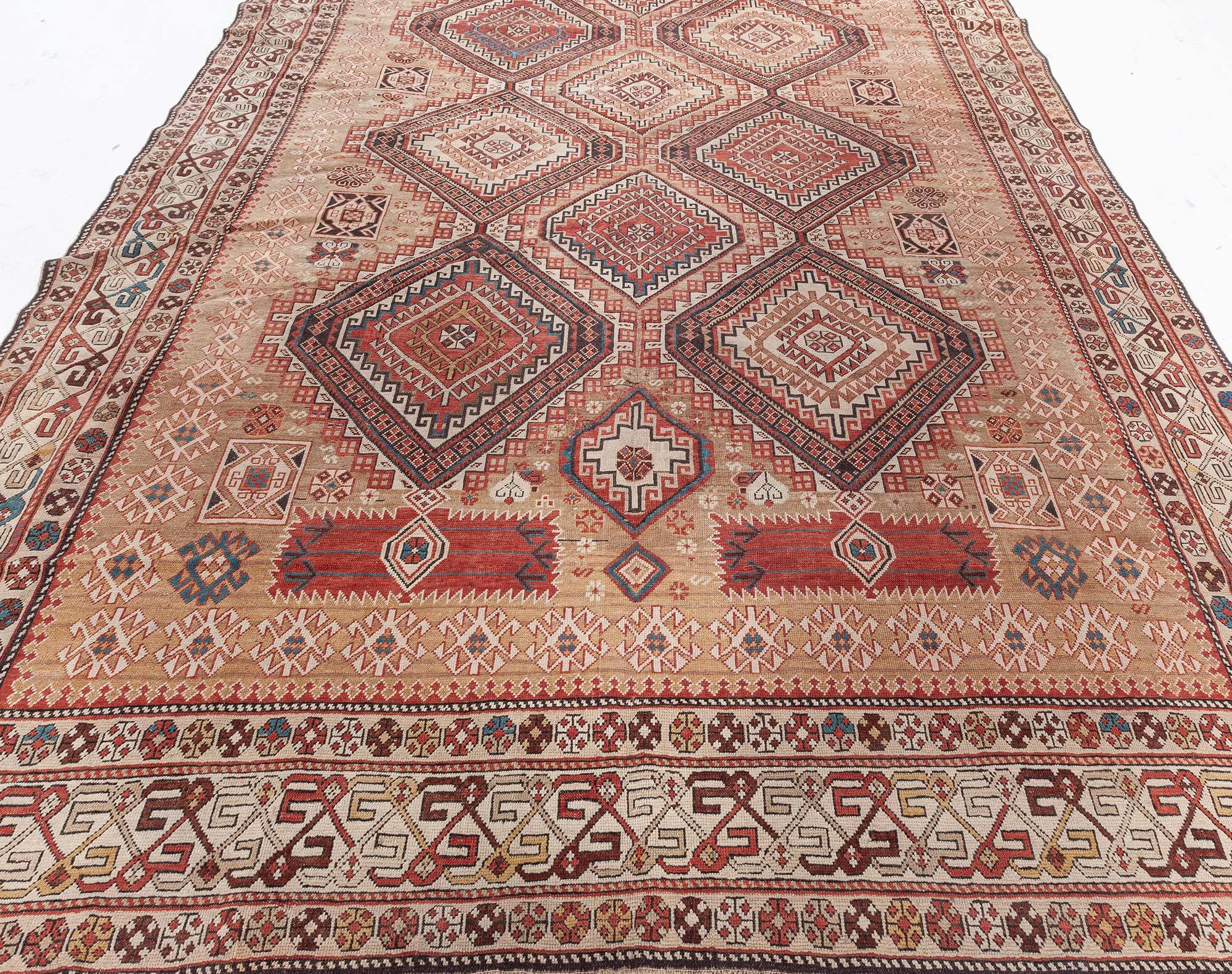 One-of-a-kind 19th century Caucasian Shirvan handmade wool rug
An antique Persian Shirvan rug, late 19th century. A grid of interconnected diamond shapes layered with class design motifs including Greek key and cruciform shapes. Brown, coral,