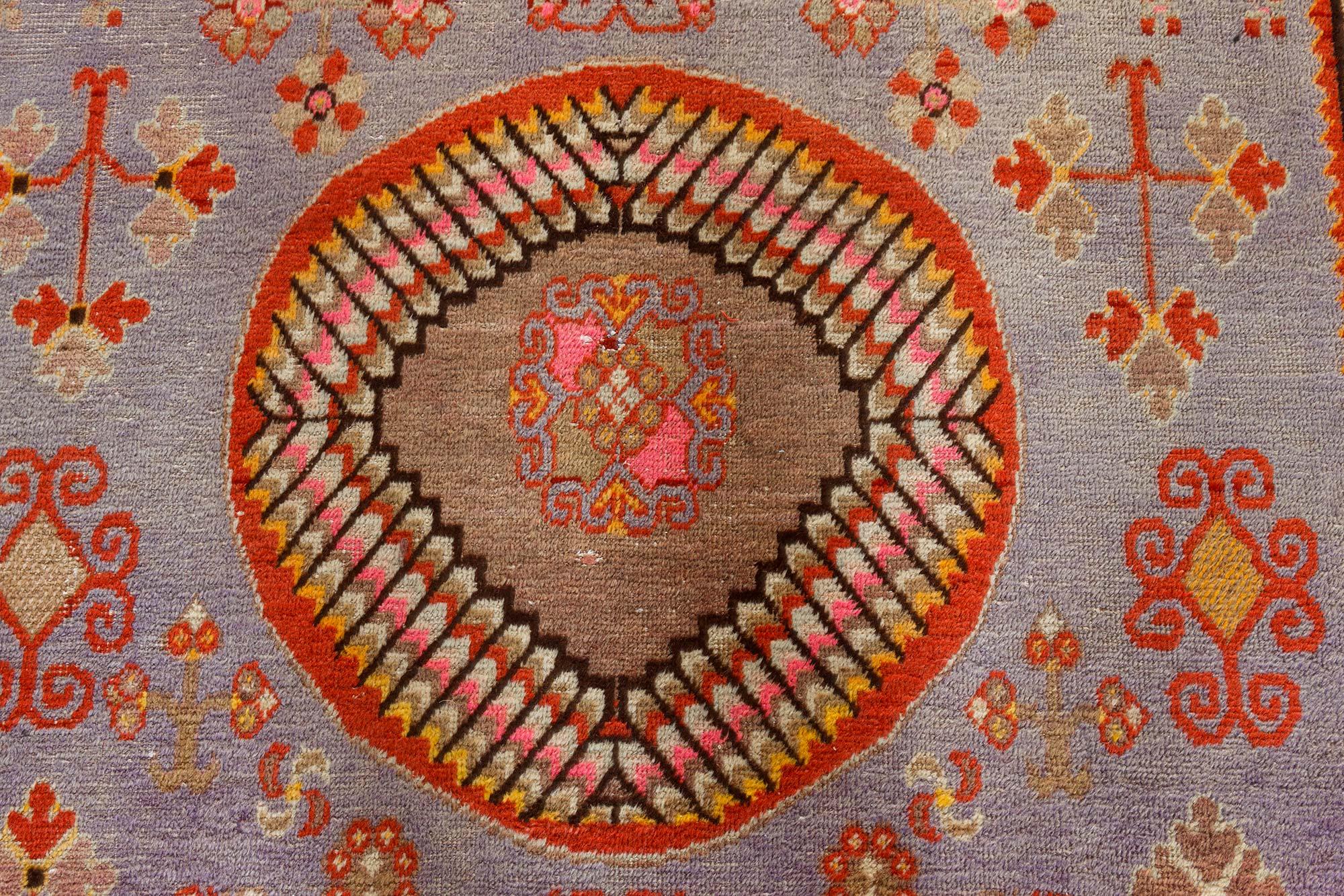 Mid-20th century Samarkand brown, gold, orange, pink, purple, and red wool rug.
Size: 6'5