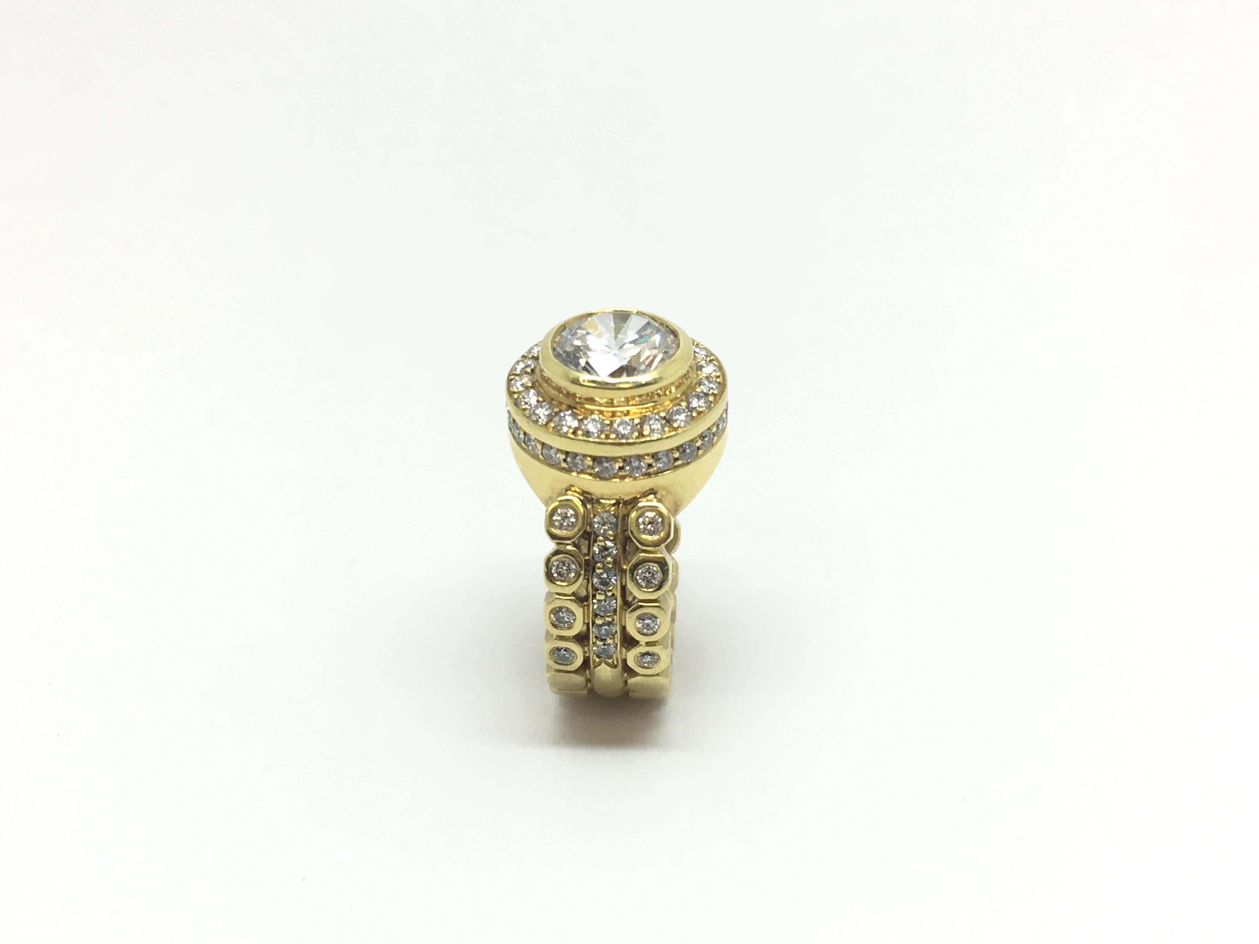 Doris Panos 18kt yellow gold semi mount ring with cubic zirconia center 8.5mm round stone. This ring is set with approximately 1.18 carat total weight of diamonds, SI clarity, GH colour, medium to good cut. The circular design all the way around the