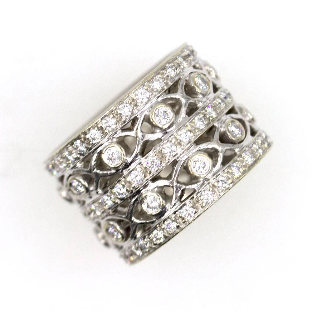 This stylish diamond band by Doris Panos features an open design. The wide band measures 15mm in width and is designed with 2.30 carat total weight of round brilliant cut diamonds. The ring is size 6.5.  