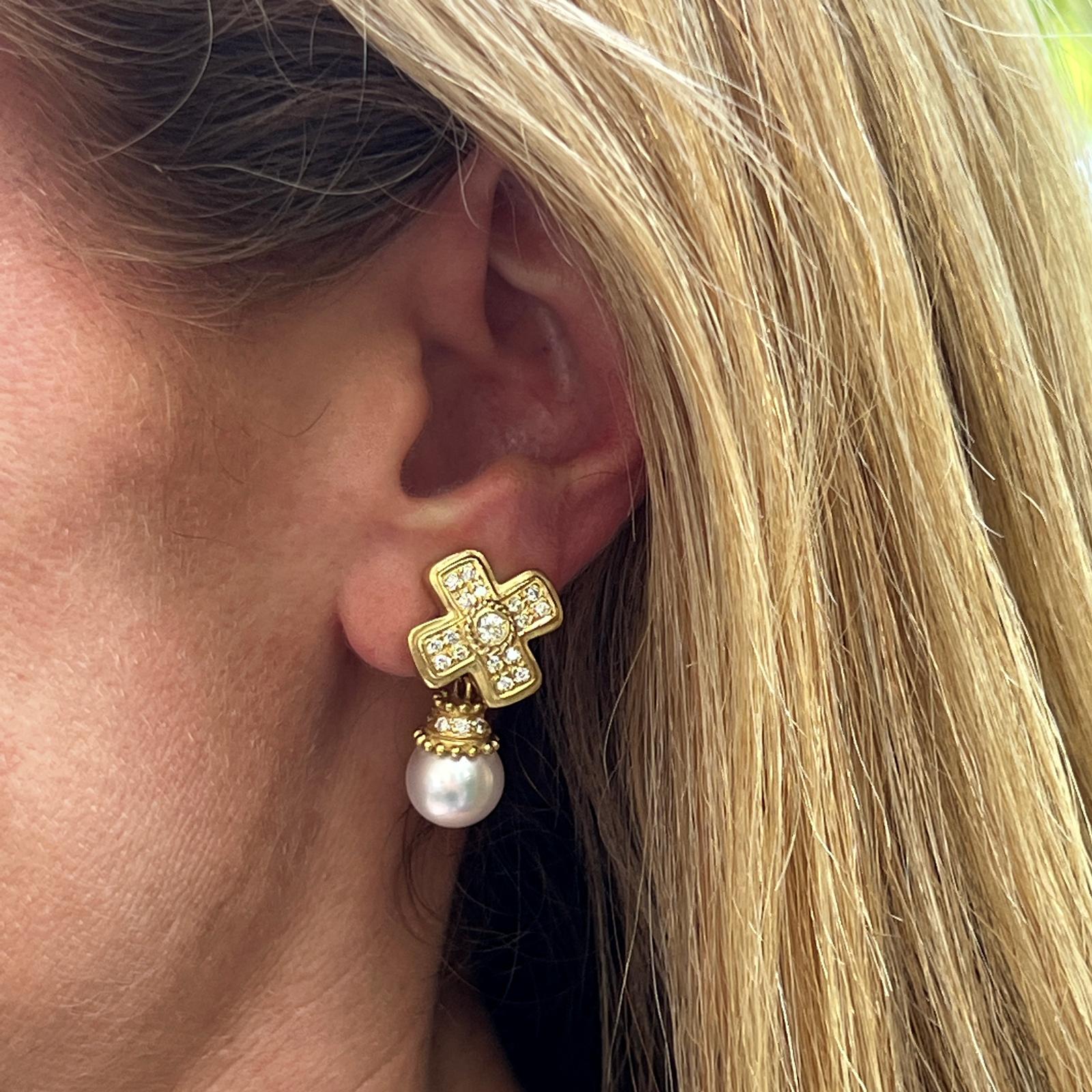 Diamond and pearl earrings by designer Doris Panos fashioned in 18 karat yellow gold. The earrings feature 46 round brilliant cut diamonds weighing approximately 1.00 CTW and graded G-H color and VS clarity. The pearl drops are detachable. The