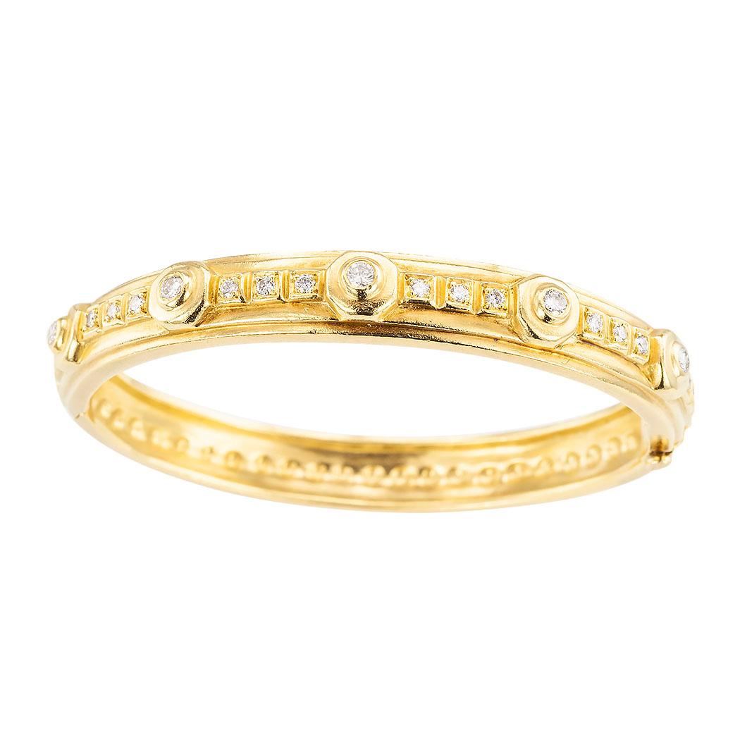 Doris Panos diamond and 18 karat yellow gold hinged bangle bracelet circa 1994.  The bracelet is set with twenty two round brilliant cut diamonds totaling approximately 0.70 carat, approximately G - H color, VS - SI clarity.  This is bracelet a