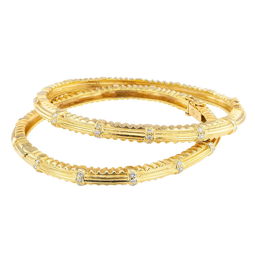 Doris Panos diamond and 18 karat yellow gold twin bangle bracelets circa 1993.  The diamonds total approximately 0.60 carat, set on the top half of each bangle bracelet.

Specifications:
Diamonds:  forty-two round brilliant-cut diamonds totaling
