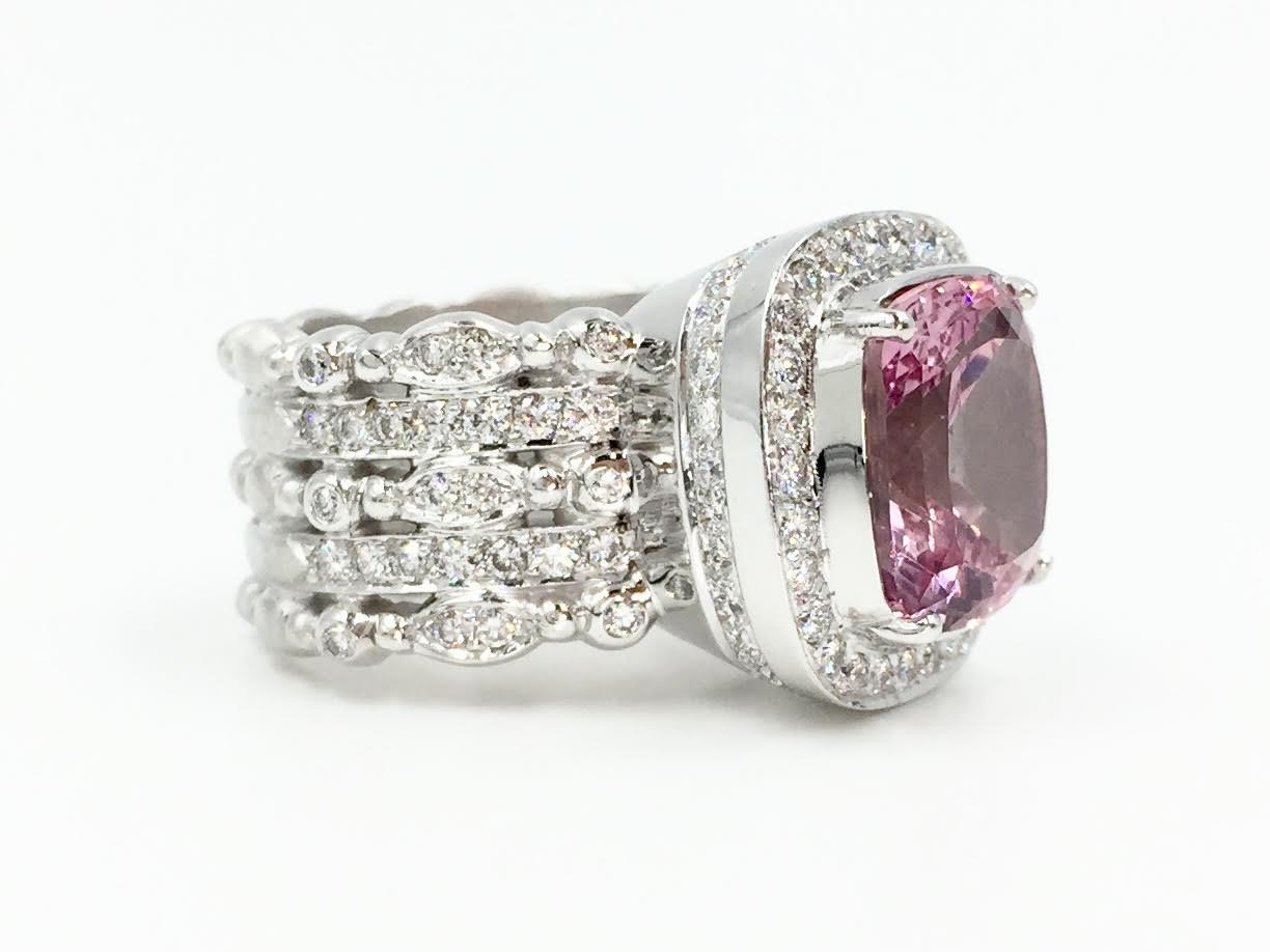 Signed Doris Panos solid 18k white gold wide cocktail ring made with superior quality and beauty from every angle. Center cushion cut vivid pink tourmaline has an approximate weight of 5 carats surrounded by a halo of white diamonds. With a