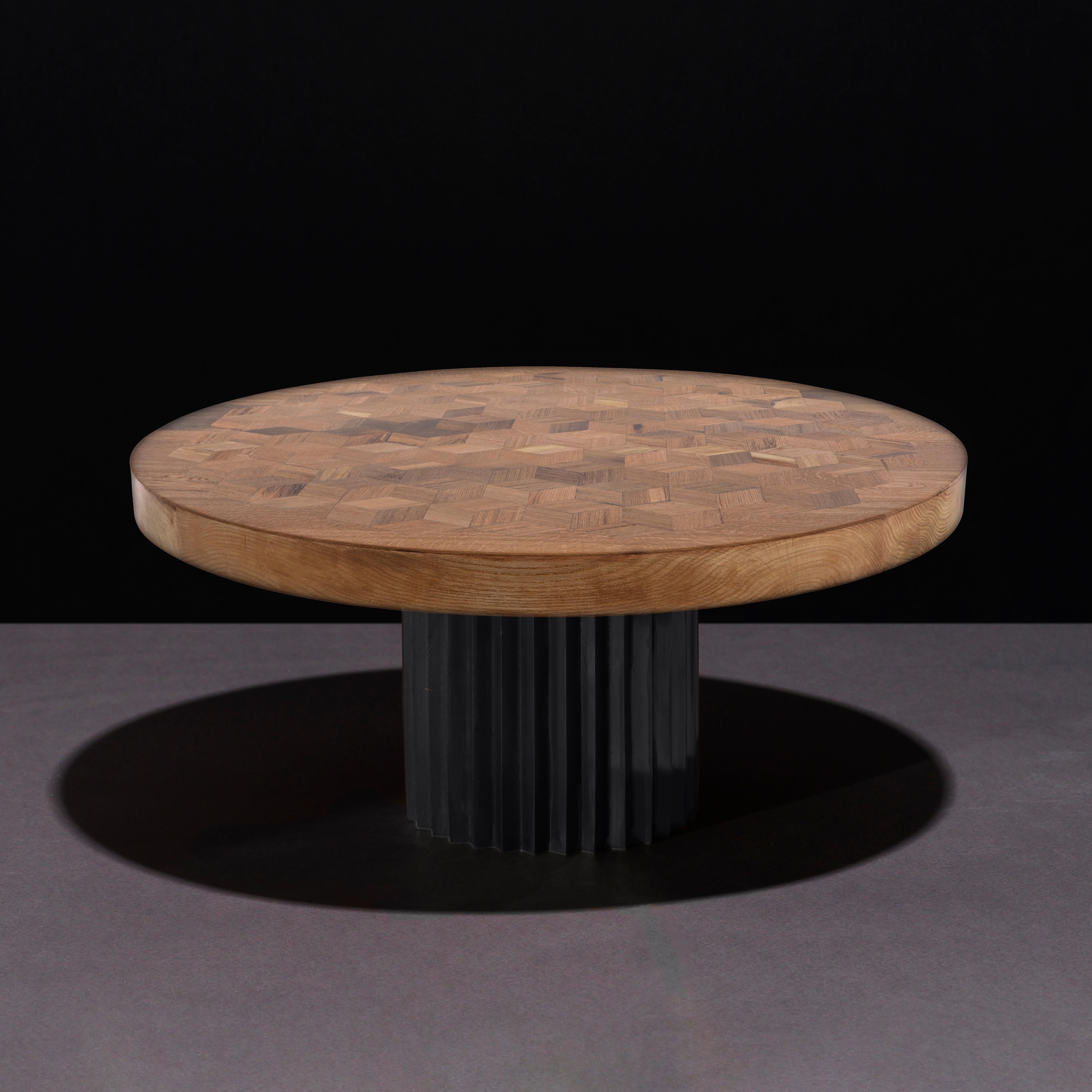 Dining or entrance table with marquetry top in reclaimed oak and multifaceted pedestal in cast blackened bronze. 

The marquetry tabletop in reclaimed Oak contains 222 rhombi cut from old Italian wine barrels. Inspired by Doric columns in archaic