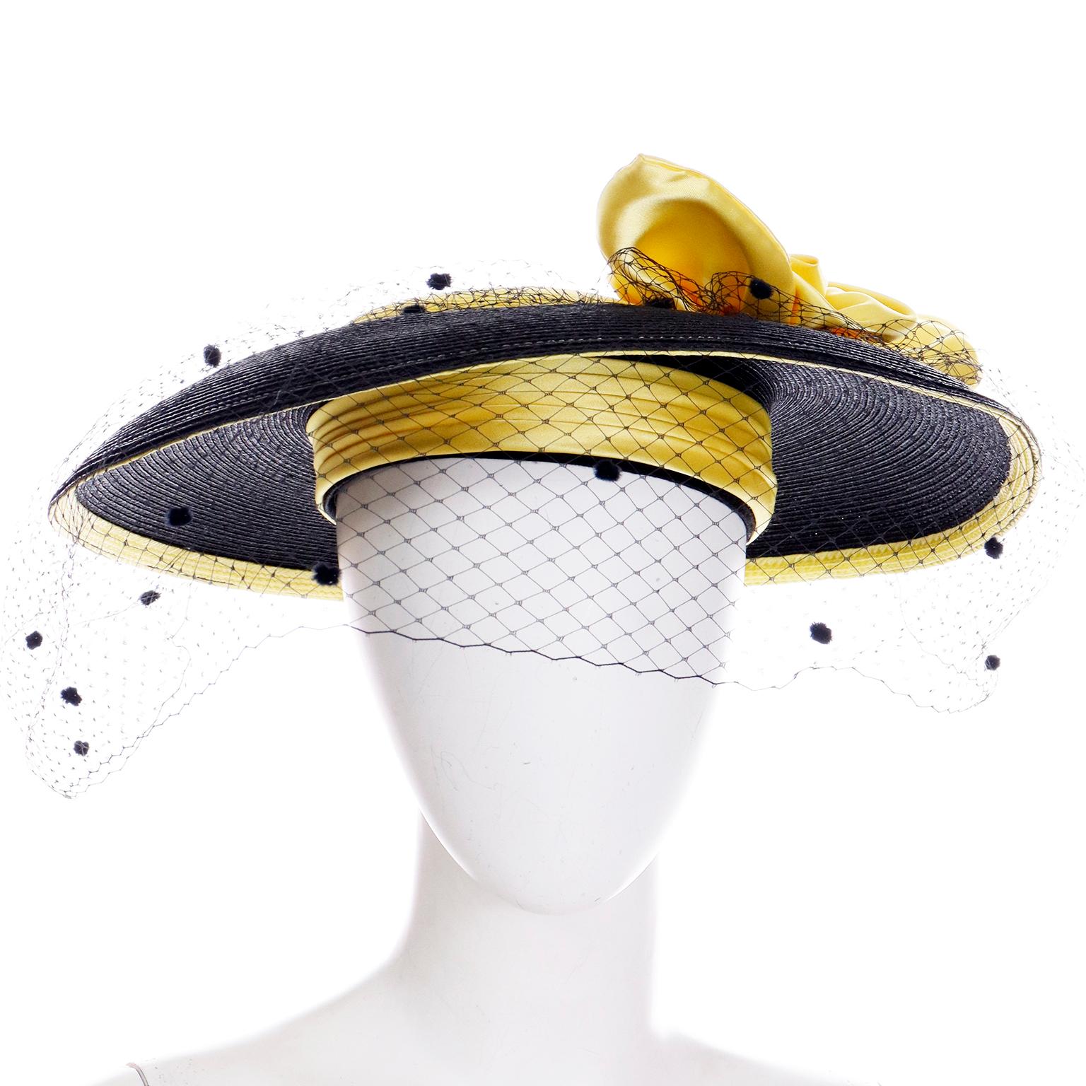 This is a vintage Doris mid century black woven coated straw hat with a yellow crown and yellow satin rose with black polka dot mesh overlay. The brim is slightly longer in length in the front and we love the way the hat fits! This hat was acquired
