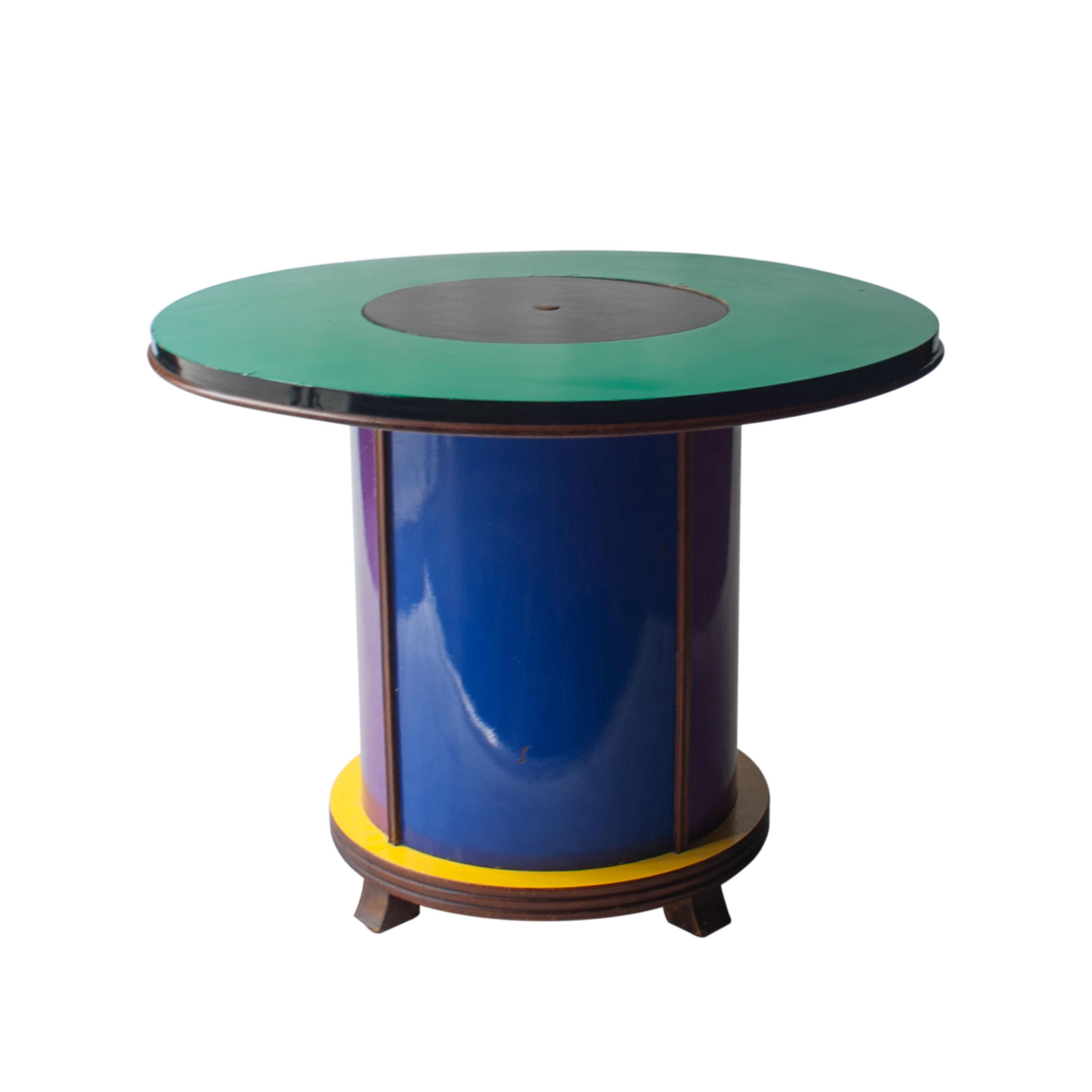 Circular cabinet bar with wooden structure covered in purple, yellow, red, green, black and white melamine with central mechanism that lifts a bar cabinet. Designed by Doro Cundo and edited by Singer & Sons in Italy in the 1980s.