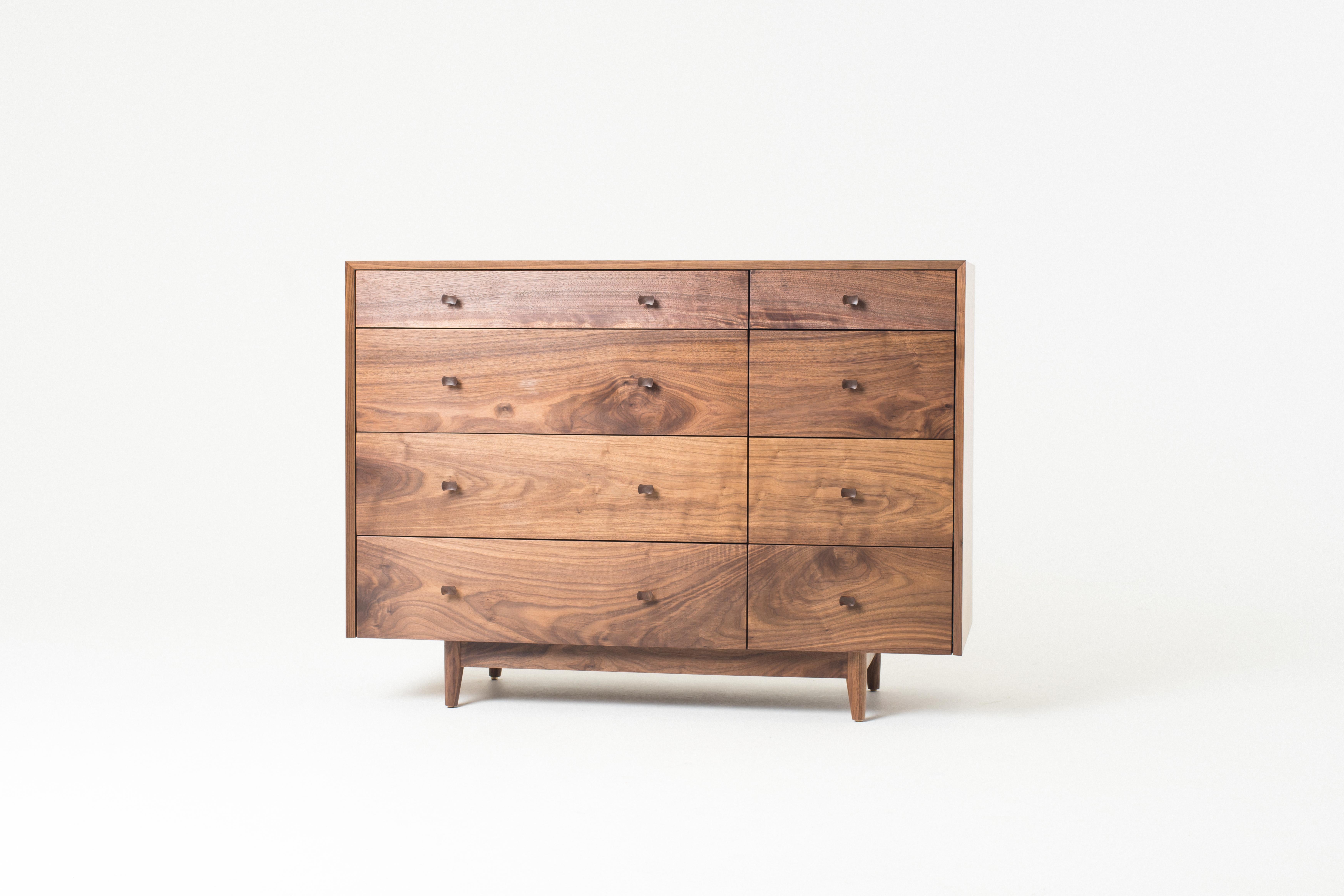 The Dorothy Bureau is a solid wood chest of drawers with a continuous grain matched waterfall miter from side to top to side. The drawer fronts are grain matched. 8 solid maple drawer boxes slide easily on self closing slides. The flume knobs are