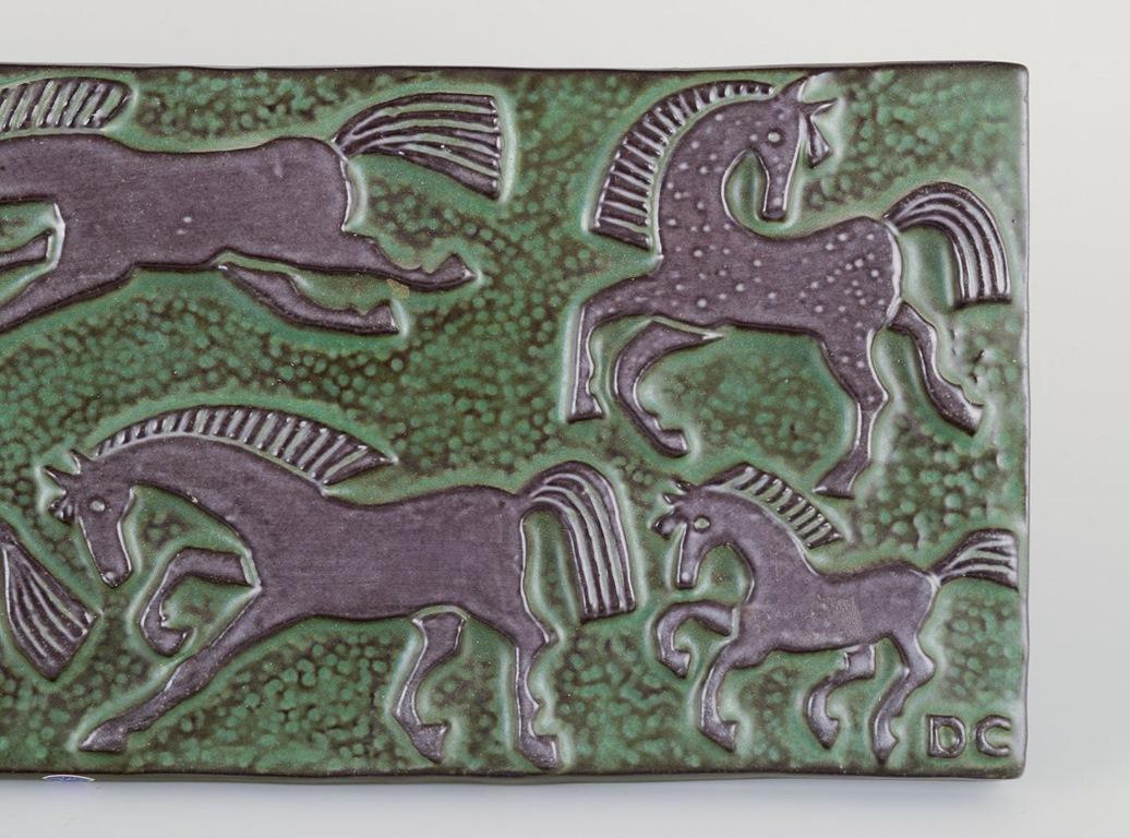 Pre-owned goods are exempt from import duties for U.S. customers. 
Therefore, no import tariffs will be applicable to your purchase.

Dorothy Clough for Upsala-Ekeby, Sweden.
Wall relief in ceramic.. Motif of horses at a gallop.
Black glaze on green