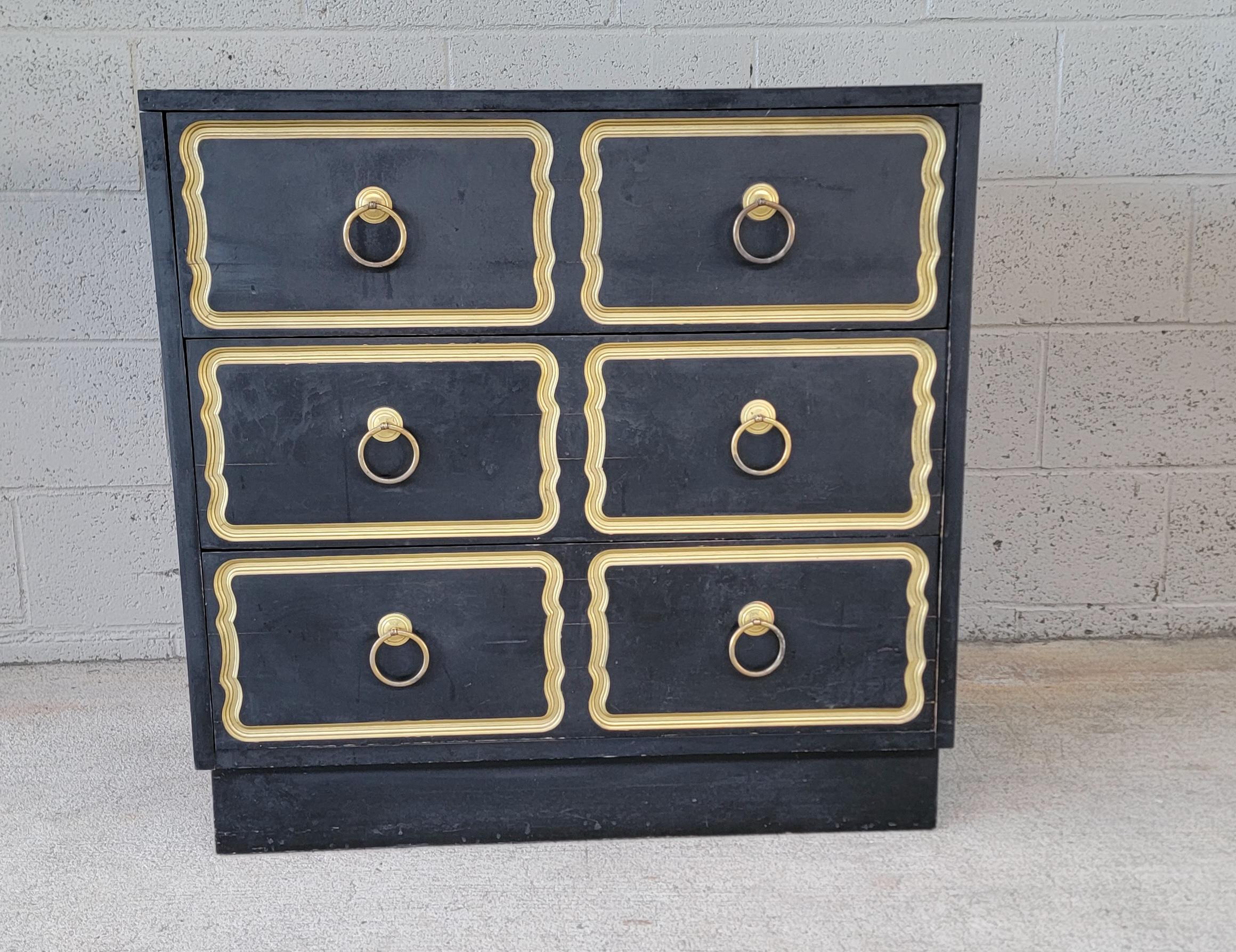 Chest of drawers attributed to Dorothy Draper. Three drawers with dovetail construction. Original black and gold painted finish. Original hardware. Wear from age and use. 