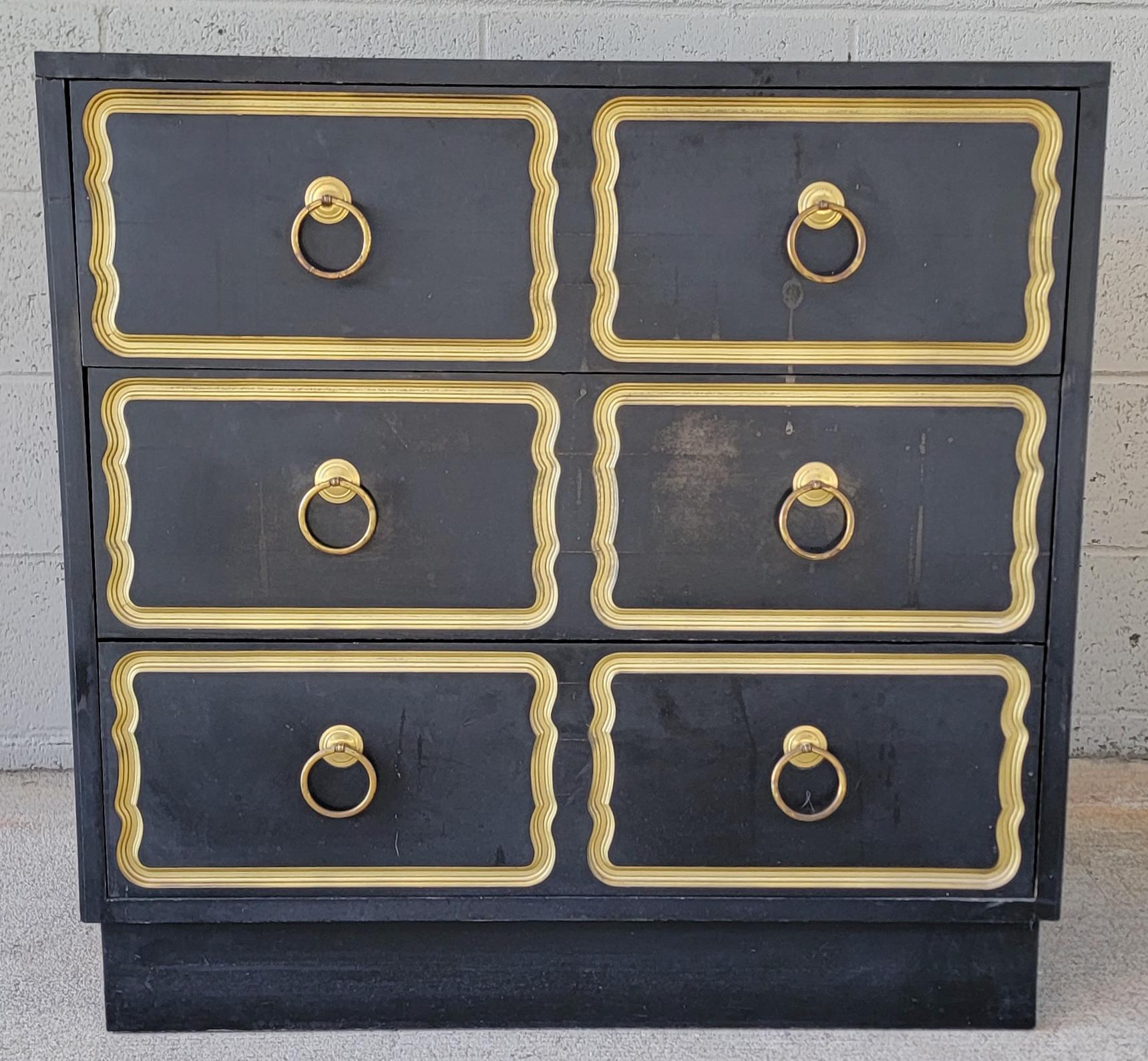 Chest of drawers attributed to Dorothy Draper. Three drawers with dovetail construction. Original black and gold painted finish. Original hardware. Wear from age and use. If a pair is desired, we have the matching chest posted.