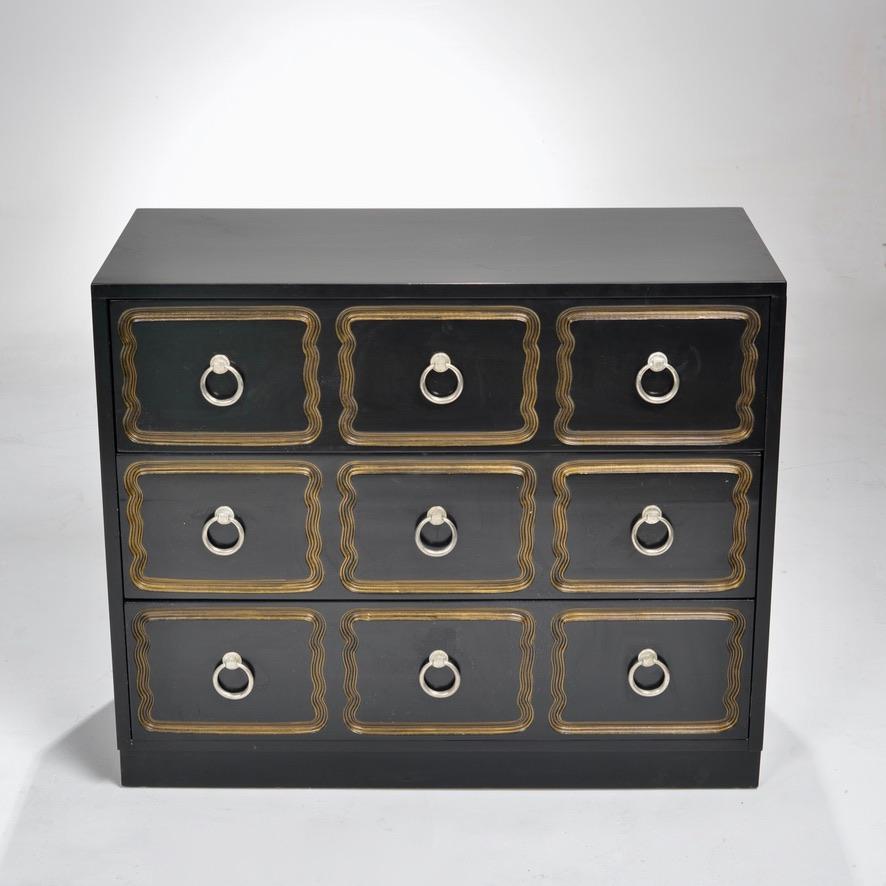 Black lacquered chest of drawers or dresser with carved gold leaf detail. Designed by Dorothy Draper. 




 