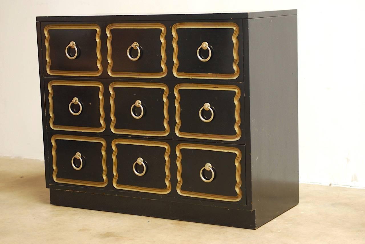 Iconic Dorothy Draper for Henredon España chest of drawers or dresser. Featuring a three drawer case decorated in the famous Hollywood Regency gilt and black lacquer finish. In as-found condition with good joinery and a worn finish with faded