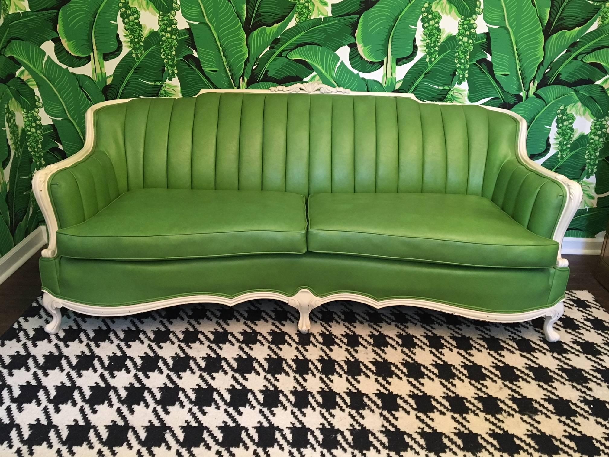 Striking green leather upholstery and a clean white frame make this beautiful vintage sofa the perfect example of Dorothy Draper's iconic style, circa 1960s. Excellent condition. Leather is near perfect and frame has only minor abrasions consistent