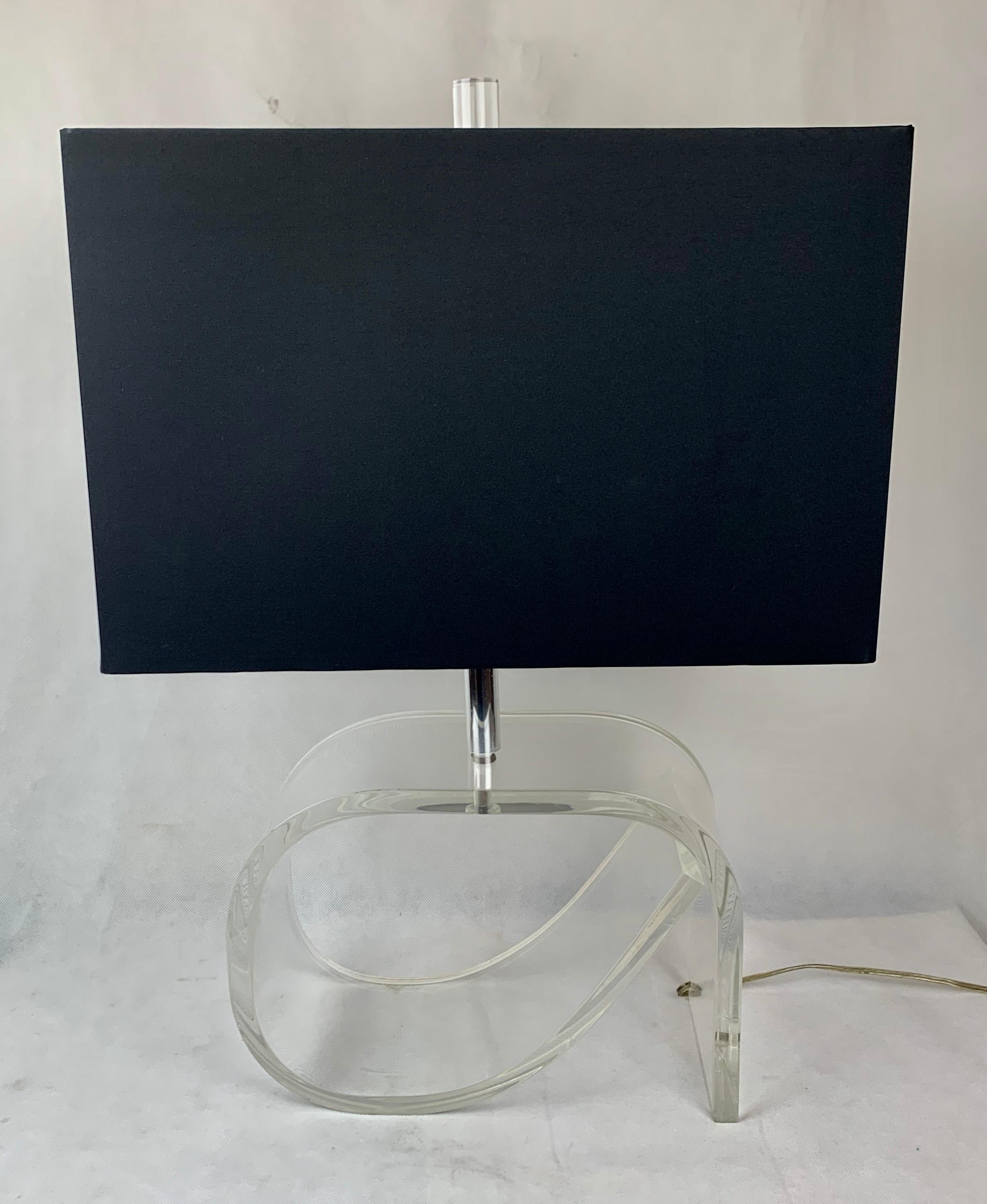 Mid century Dorothy Draper style lucite lamp with a new black rectangular shade and matching lucite finial.
This hand crafted lucite lamp is electrified in a unique way. On the back side a small channel is made in the lucite panel edge just narrow