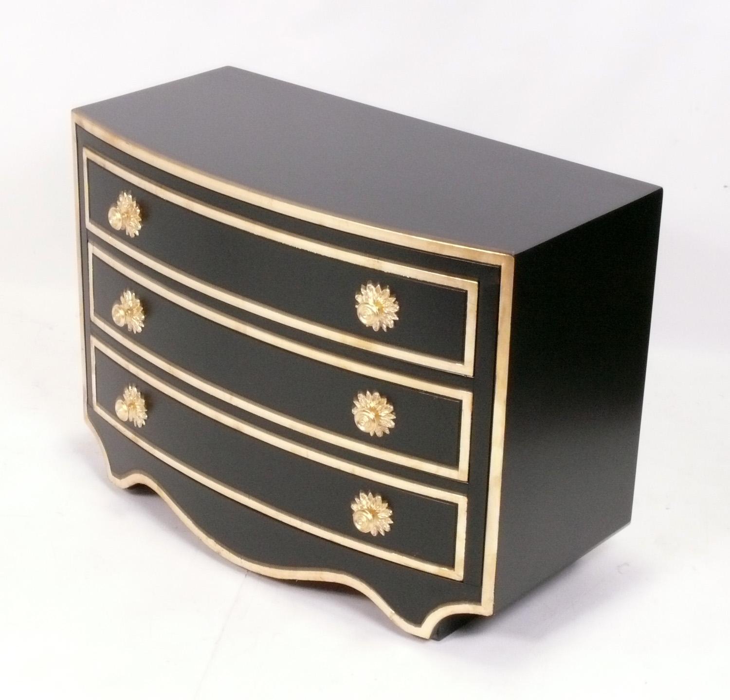 Elegant Chest or Dresser, designed by Dorothy Draper for Henredon's Viennese Line, American, circa 1950s. This chest has recently been completely restored in black lacquer and gold leafed or gilt trim and hardware. 