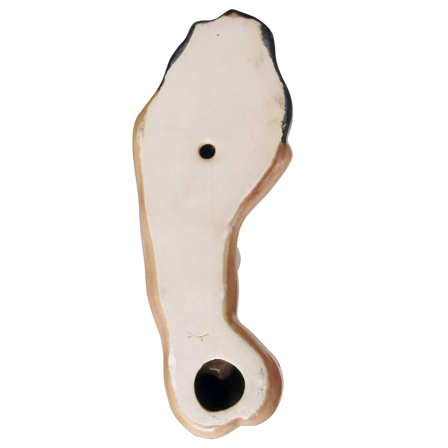 California artist, Dorothy Kindell, produced unique figurines and gift-ware in the 1940s-1950s. Her clever figural ceramic art has become popular and highly collectible in recent years.

This particular Kindell piece mounts to the wall, with the