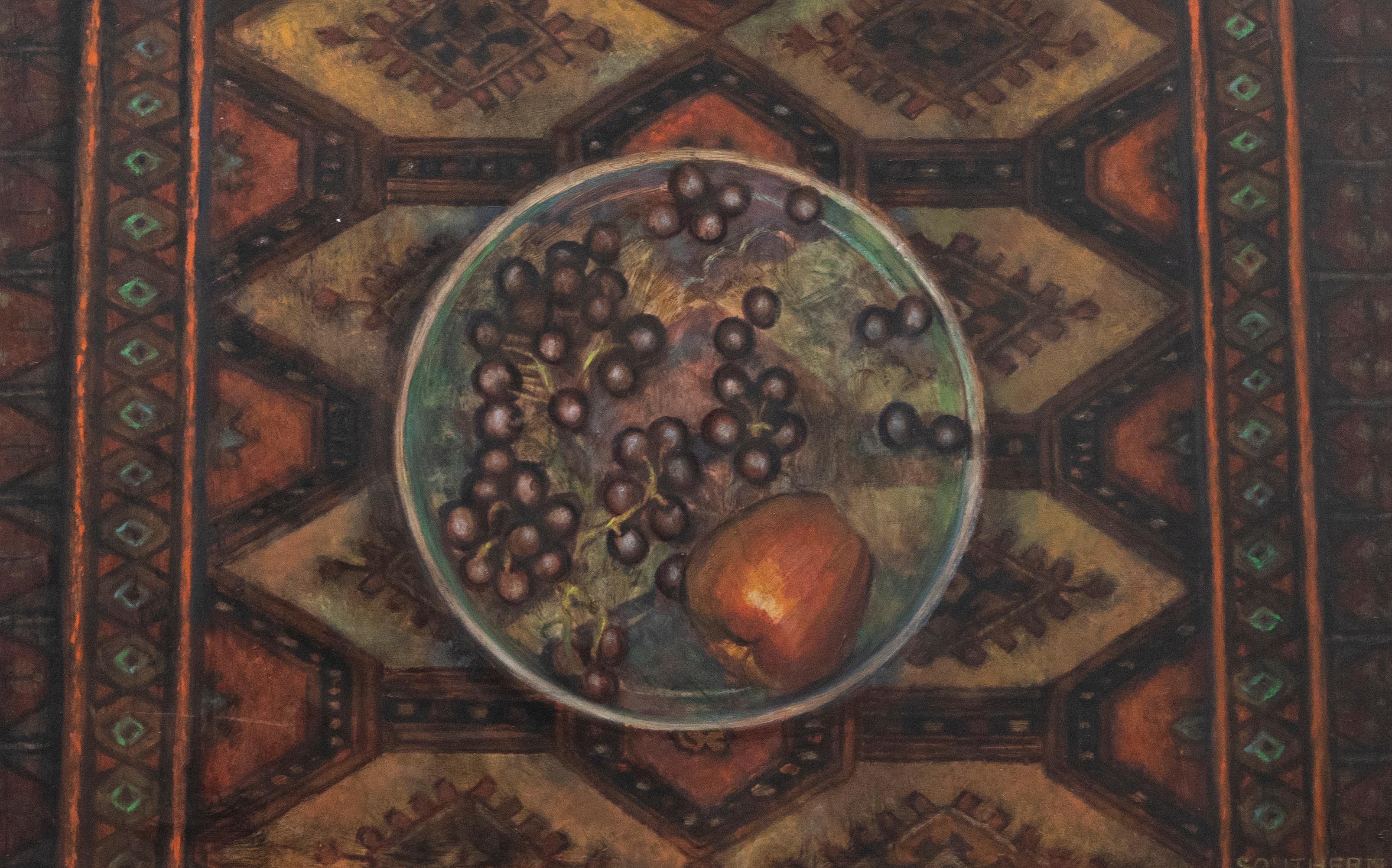 An fine study depicting an aerial view of a bowl of grapes and an apple placed on a patterned surface. The artist captures the textile surface in rich, jewelled colours that adds a sense of luxury to the still life scene. Signed to the lower right.