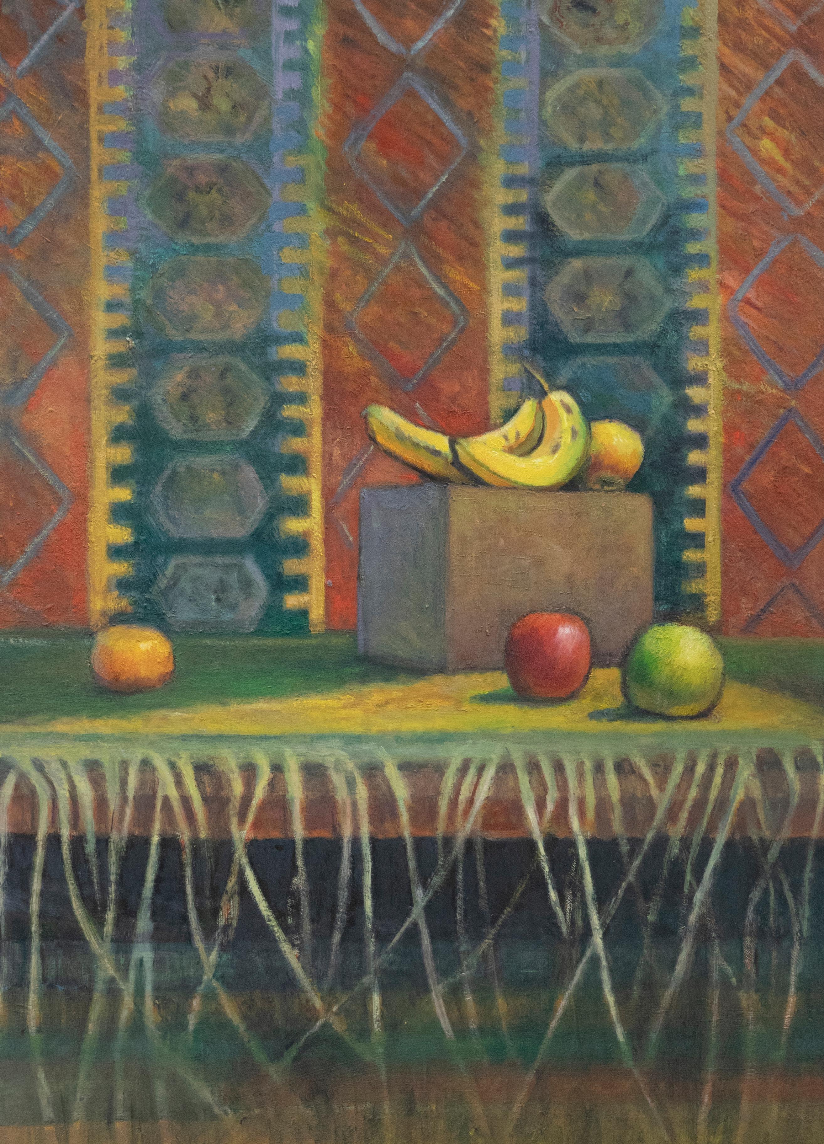 A delightful still life study depicting oranges and apples carefully placed before a patterned wall hanging. The artist uses a vibrant palette capturing the bold primary colours the textiles for a vibrant backdrop to the still life objects.