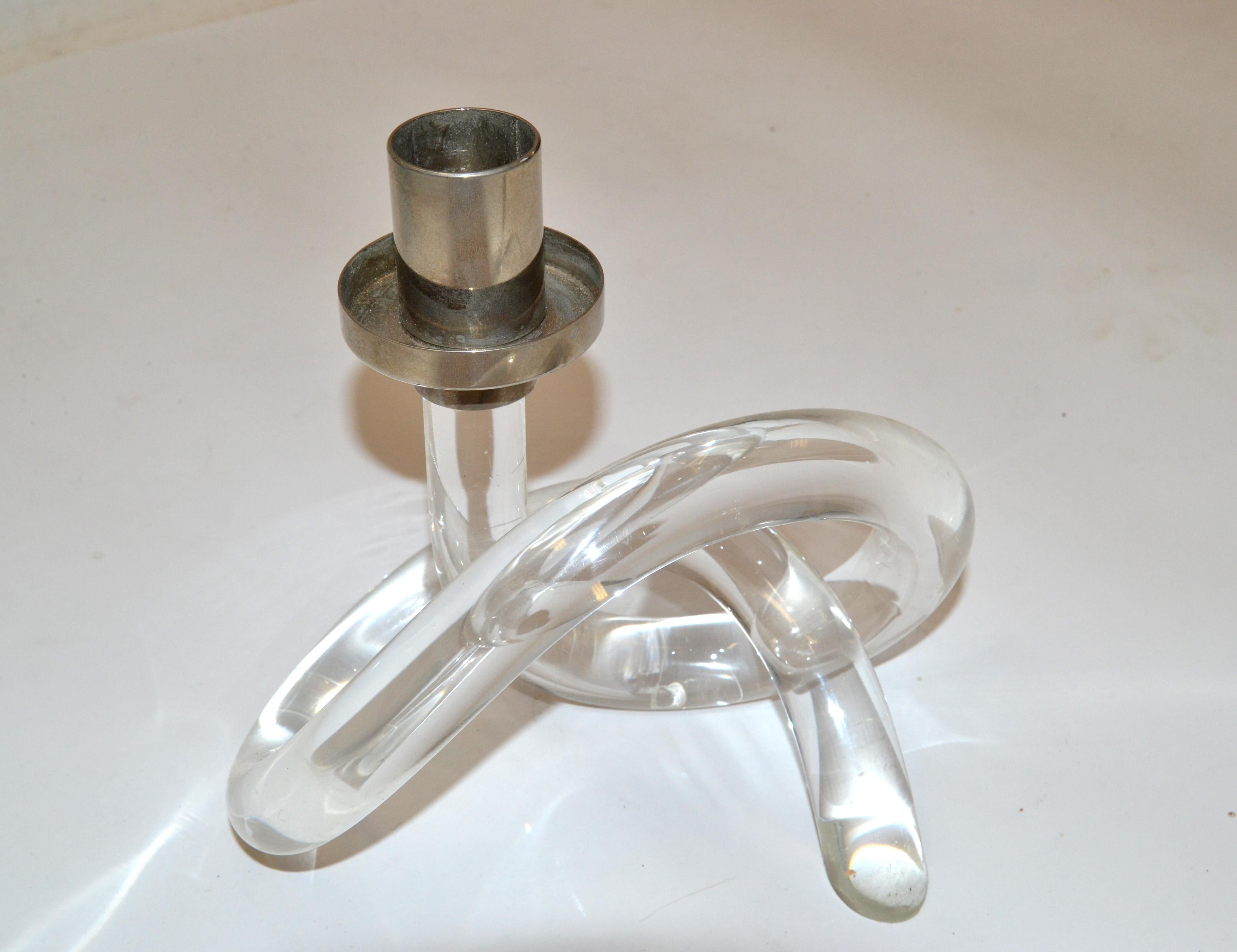 Beautiful, rare Candleholder by Dorothy Thorpe made in America in the 1970.
Bend Lucite in pretzel shape with a nickel top for a 2.5 diameter candle.
In original vintage condition with some crazing to the Lucite.