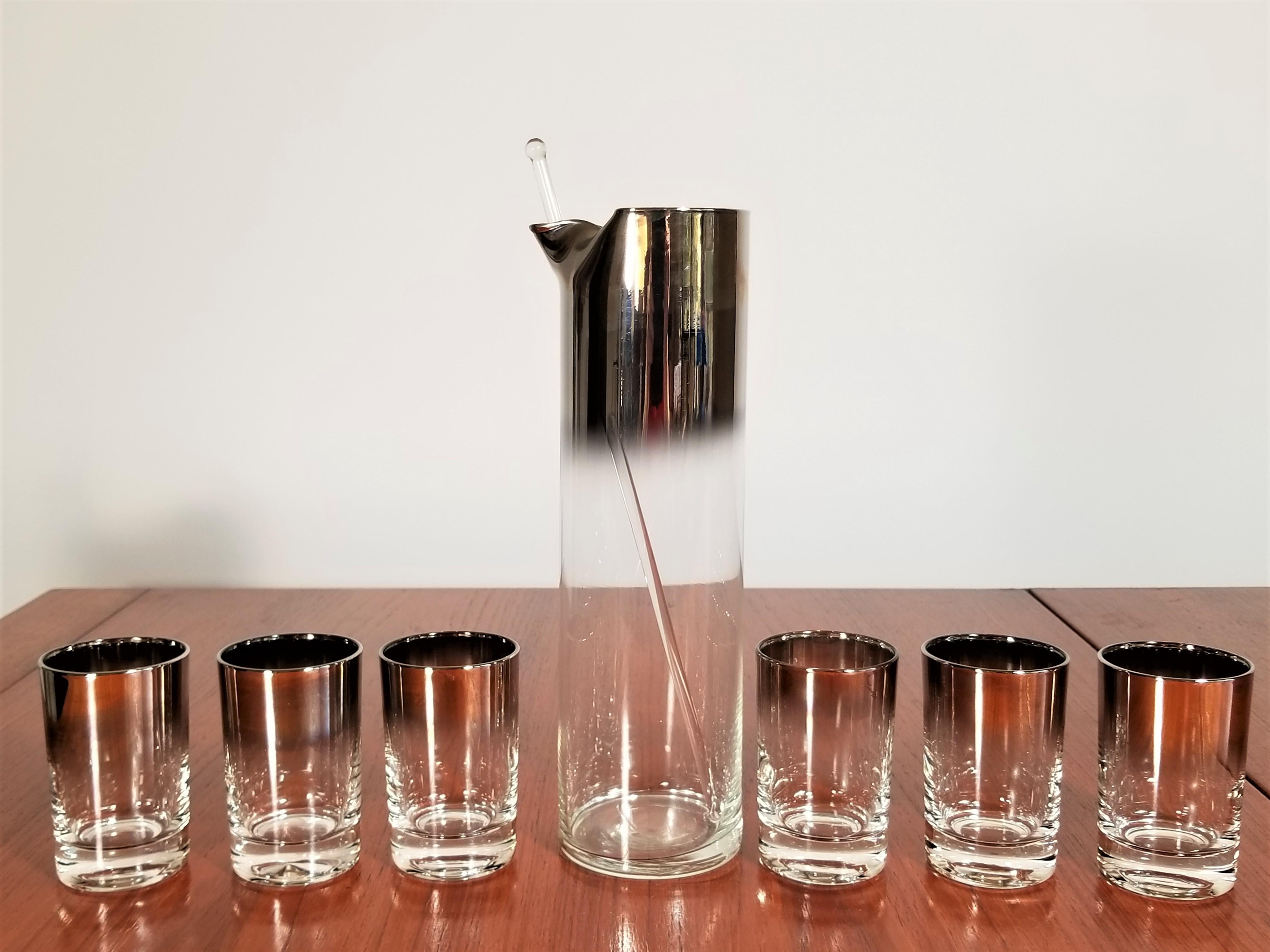 Midcentury silver glass bar set attributed to Dorothy Thorpe. Silver Fade.
One martini pitcher 10.5 x 3 inches
One glass stirrer 12 inches
Six glasses 3 x 2.25 inches.