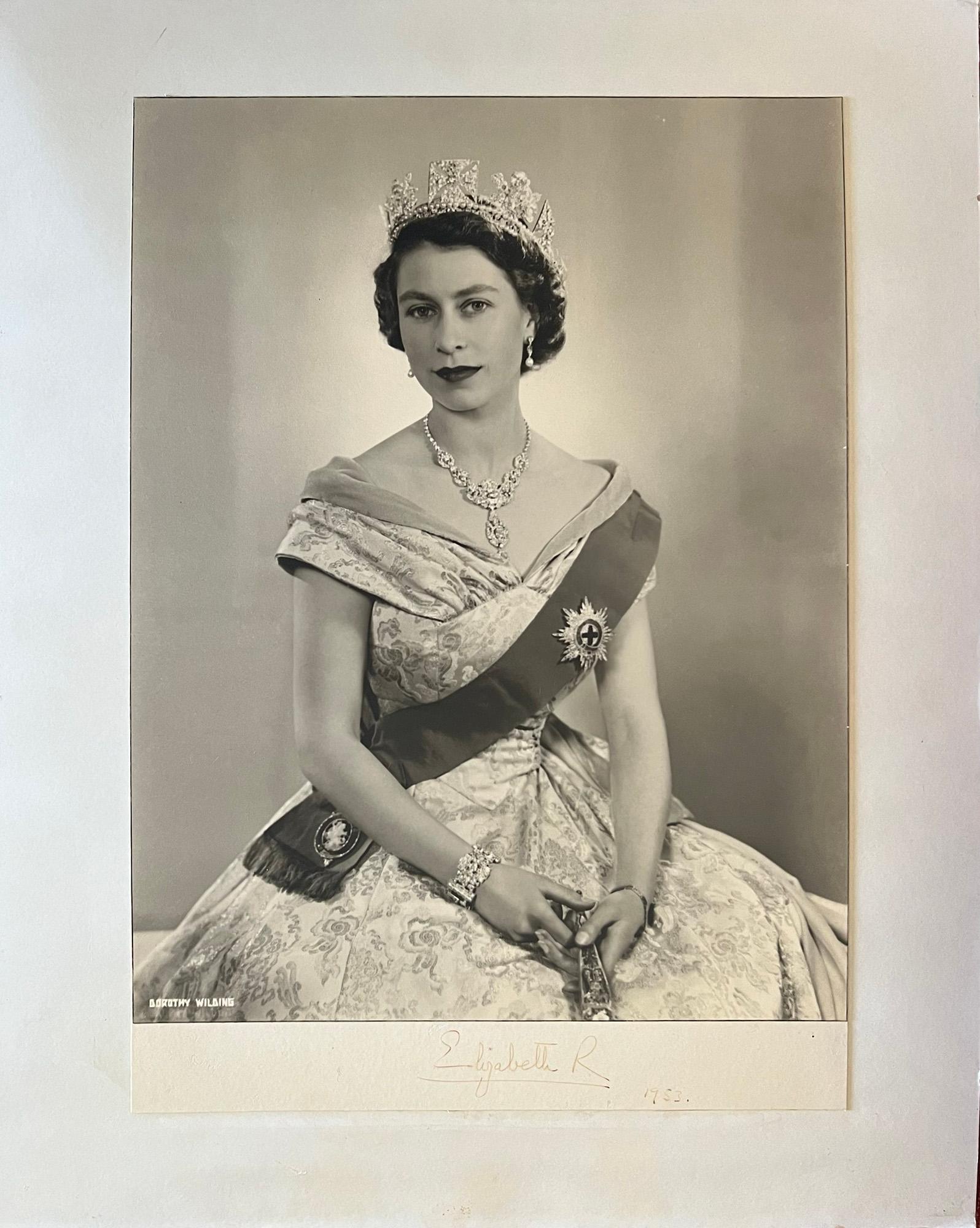 Queen Elizabeth II, portrait photograph by Dorothy Wilding.

Bromide photograph. 1953. Laid onto board. Signed by the Queen below the photograph, dated 1953. 

Dorothy Wilding was the first female Royal photographer. 

490mm by 345mm (photograph),
