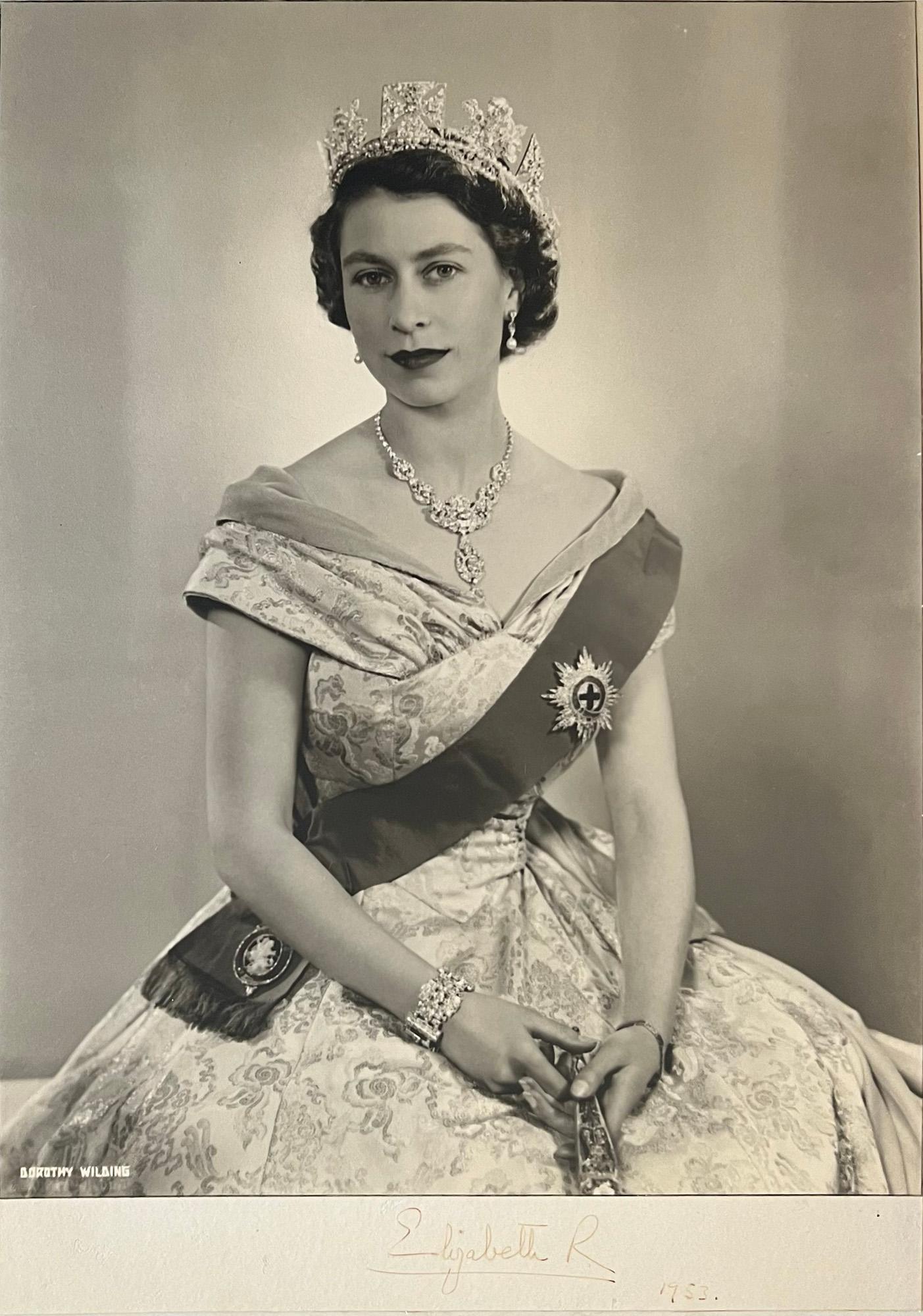 Queen Elizabeth II, portrait photograph by Dorothy Wilding.

Bromide photograph. 1953. Laid onto board. Signed by the Queen below the photograph, dated 1953. 

Dorothy Wilding was the first female Royal photographer. 

490mm by 345mm (photograph),