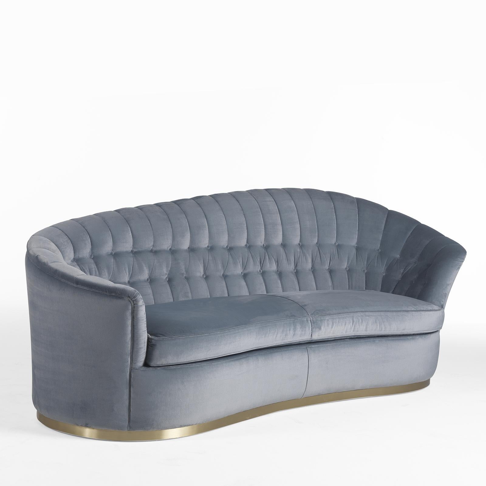 Bold and dynamic, this exclusive sofa will be a refined statement in any modern or traditional living room. Fashioned of solid wood, the dramatic frame is distinguished by the sinuous, high-low profile of the backrest that seamlessly flows into the