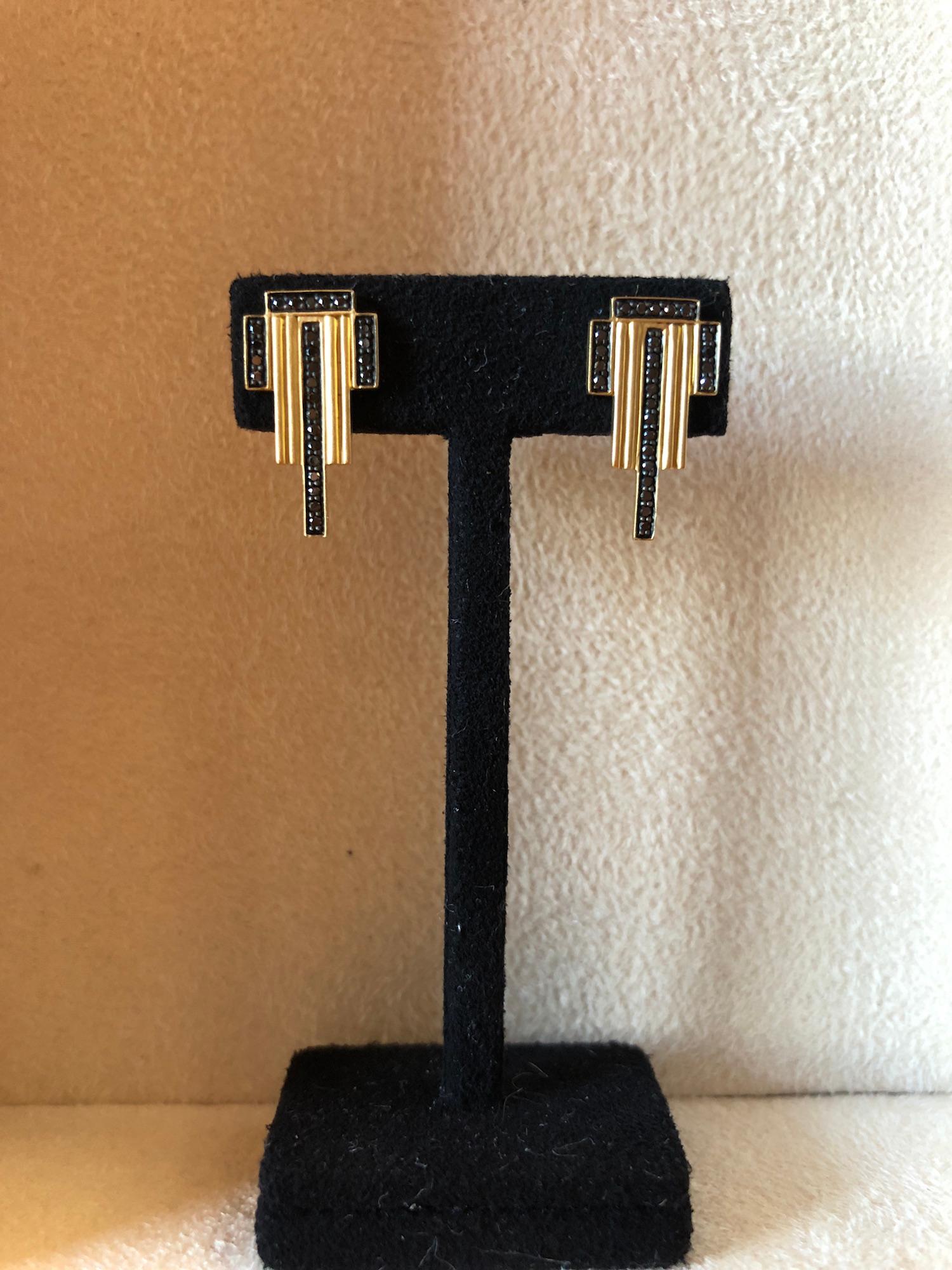 The Empire earrings, by Doryn Wallach, feature 0.22 carats of black diamonds set in a motif that recalls the Art Deco architecture of New York City.  Set in finely ribbed 18K yellow gold with satin finish, these earrings are a modern Art Deco