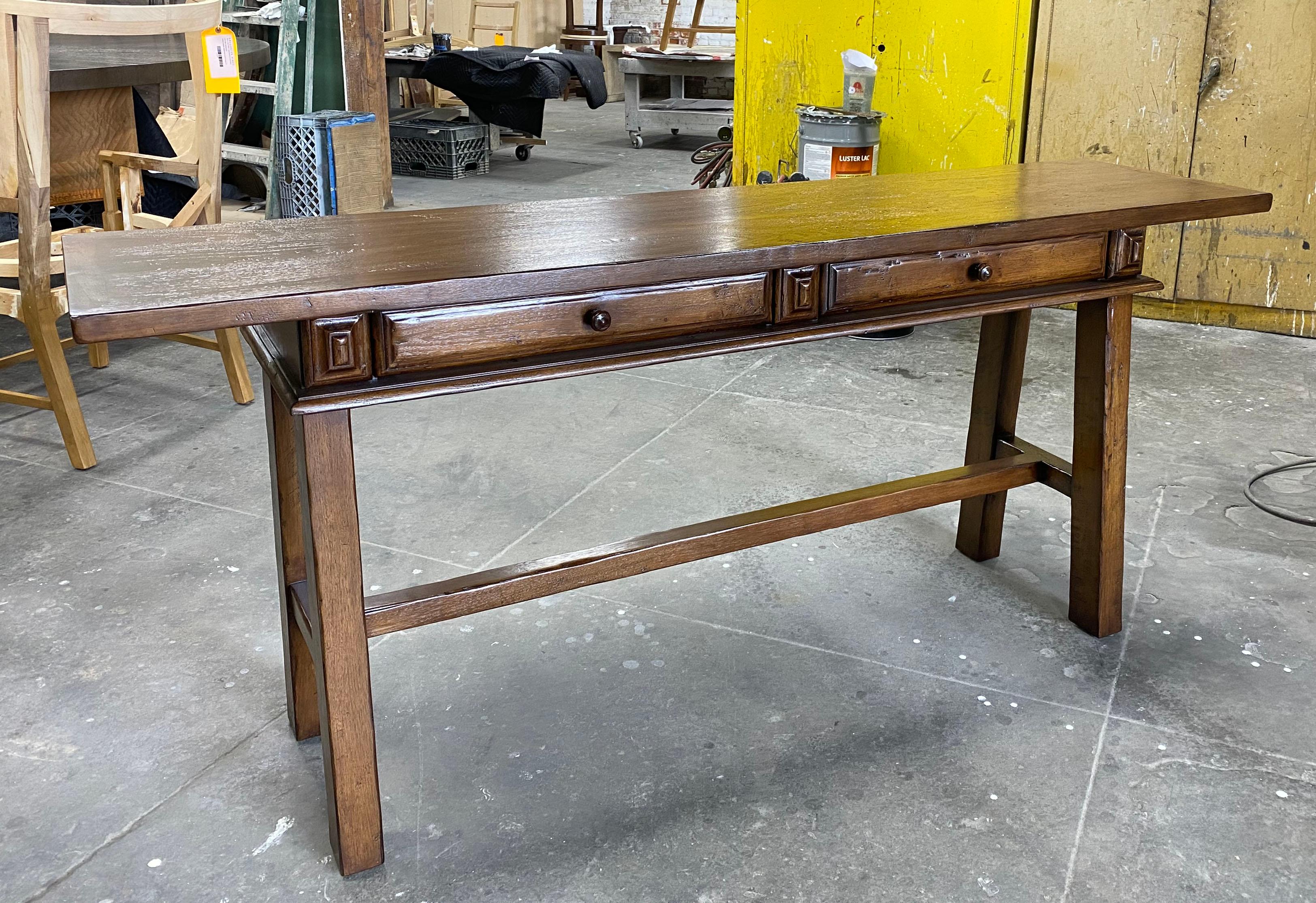 This is a Dos Gallos custom desk or console that we make to our client's specifications. It can be made in any size, with or without drawers in a range of finishes. As shown, in walnut with a Walnut #2 color and light to medium distress.
All custom