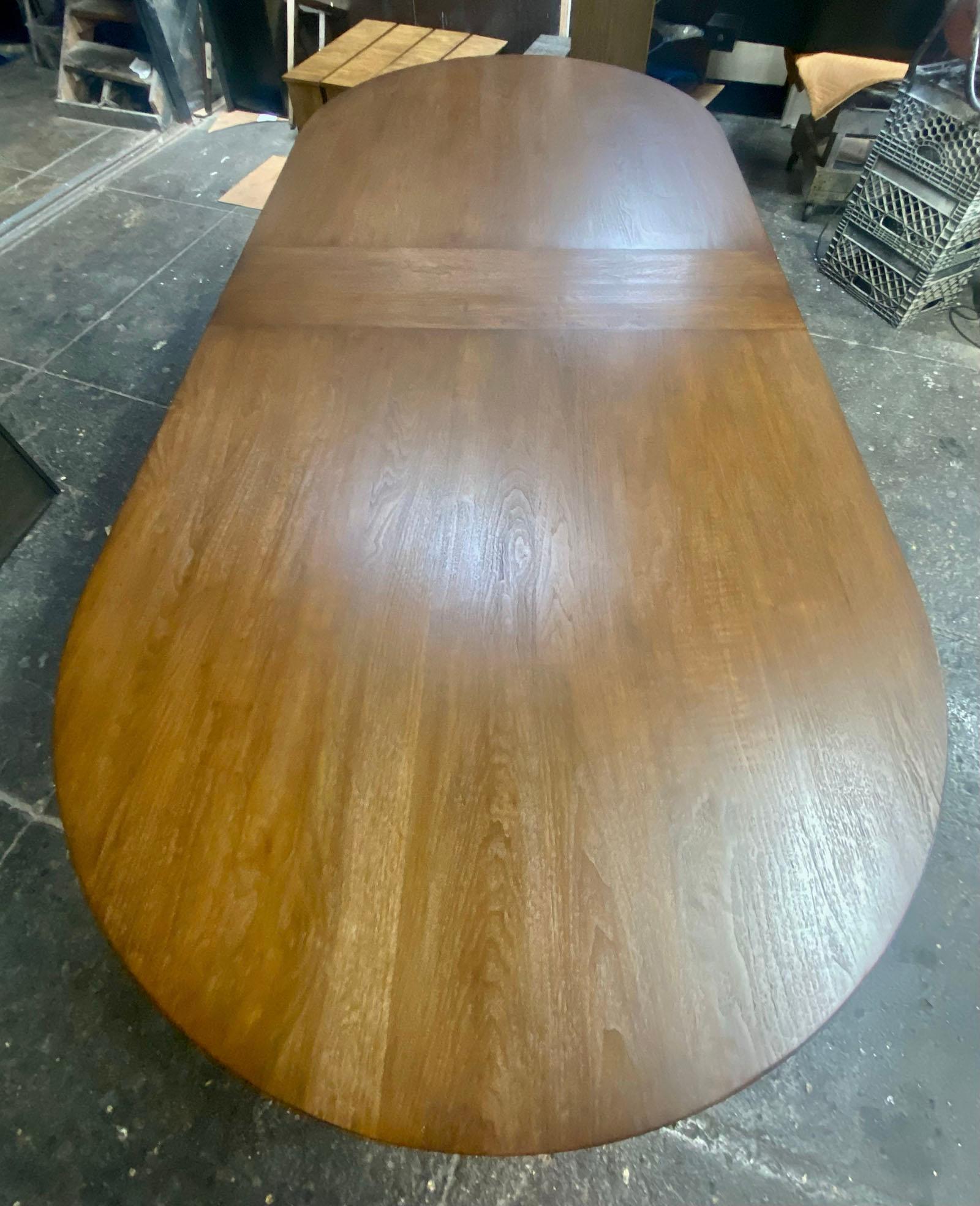 This is our Dos Gallos custom wine tasting table shown with a race track oval top. This particular table was made in Walnut with a Walnut #2 finish and light distress. The top features a breadboard in the middle.
This table is bench made and hand