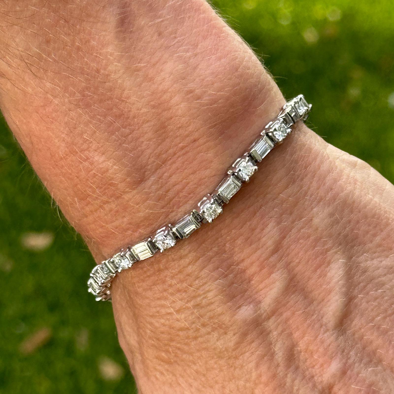 This elegant platinum dot-dash diamond bracelet features a striking geometric design with alternating round brilliant and straight baguette diamonds. Set with 17 round brilliant-cut diamonds totaling approximately 2.70 carats and 34 straight