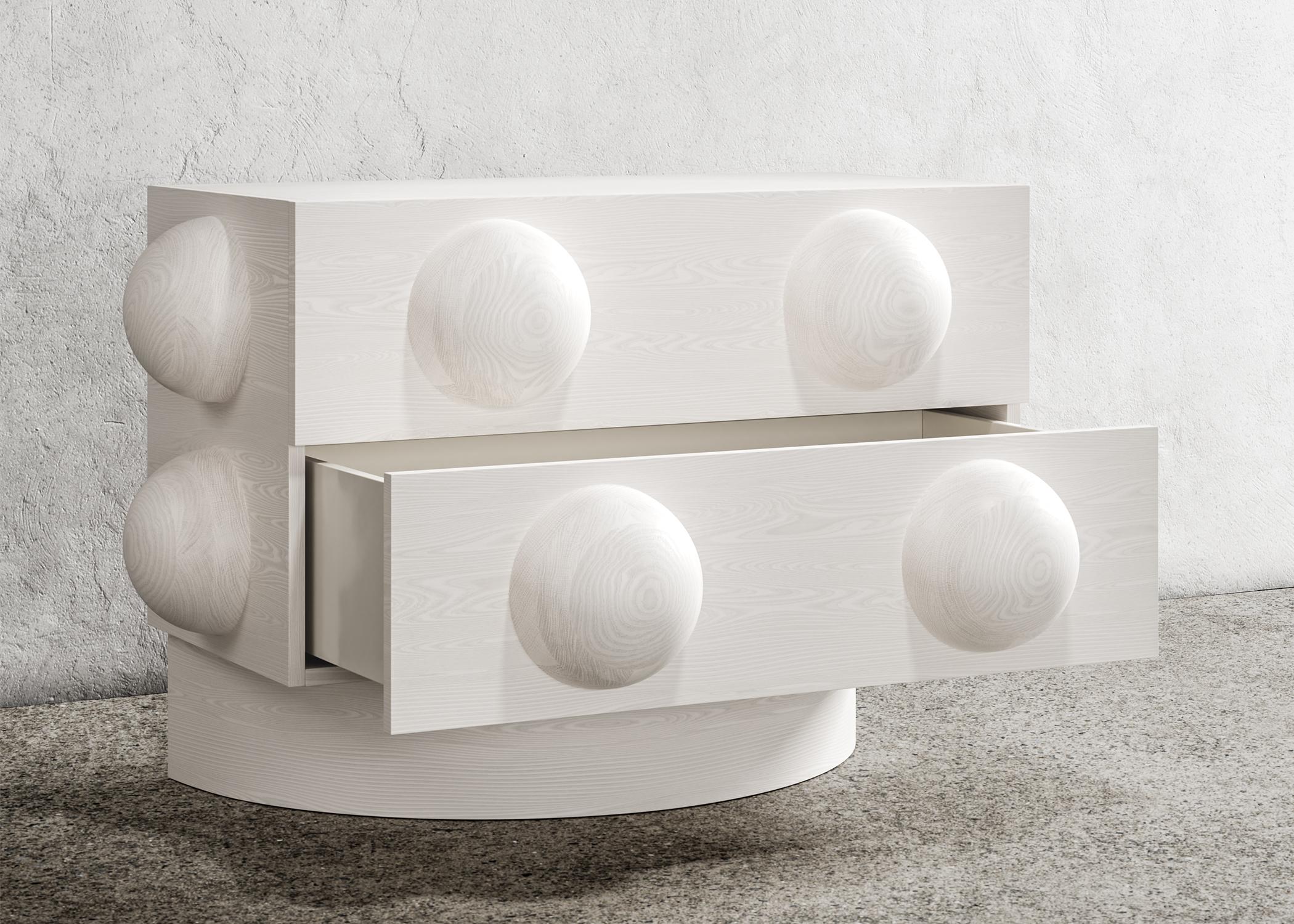 DOT NIGHTSTAND - Modern Bleached White Oak Body and Base

The Dot Nightstand is a contemporary piece of furniture with a unique design element - a sculpted wood sphere detail - and wood plinth bases, which give it an architectural feel. This modern
