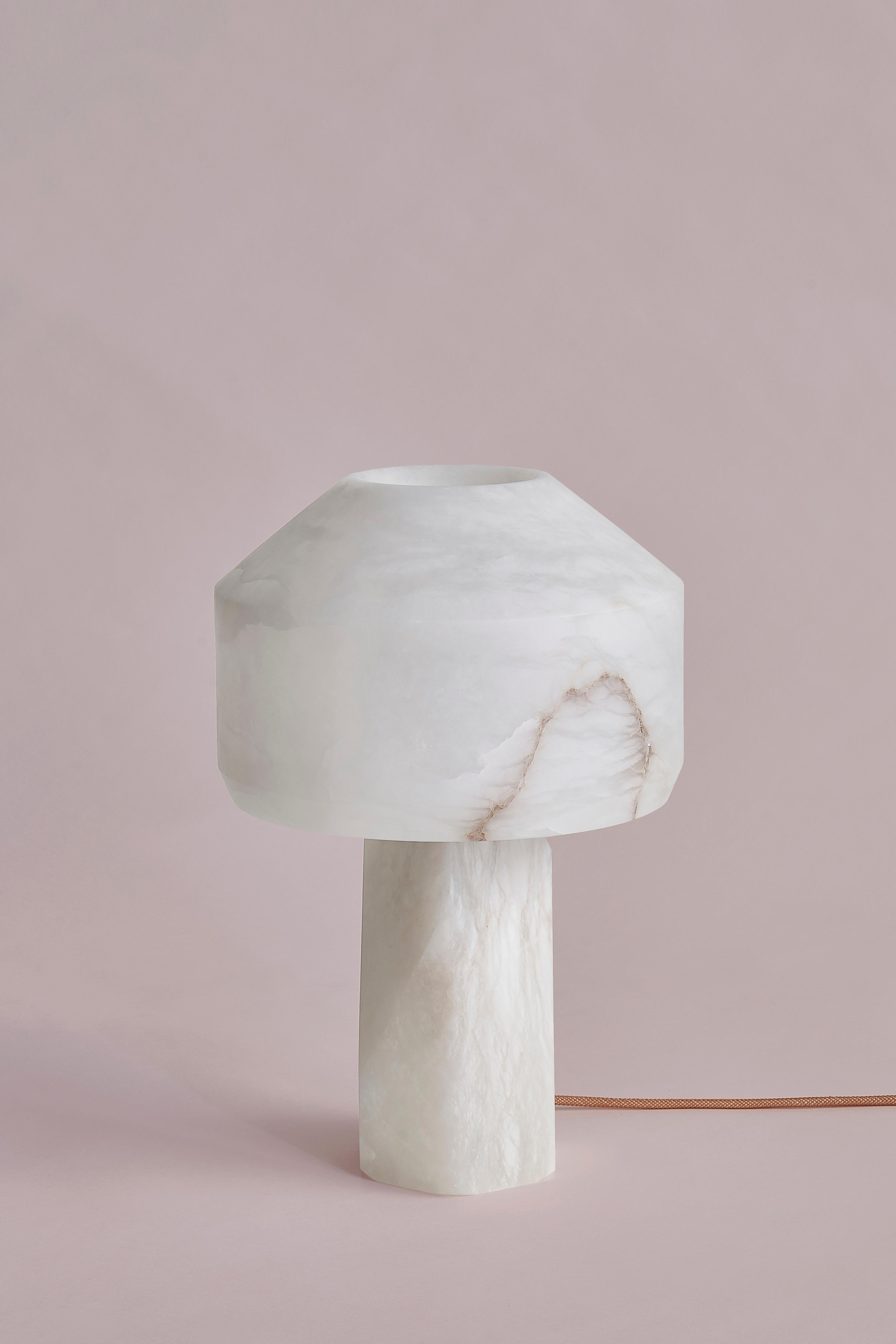 Dot Table Lamp by SB26
Dimensions: W 29 x D 29 x H 43 cm
Materials: Alabaster, LED Source.

In a consistently geometric vocabulary, this family of lamps unveils the
translucent and organic nature of alabaster.
A contrast of shapes and