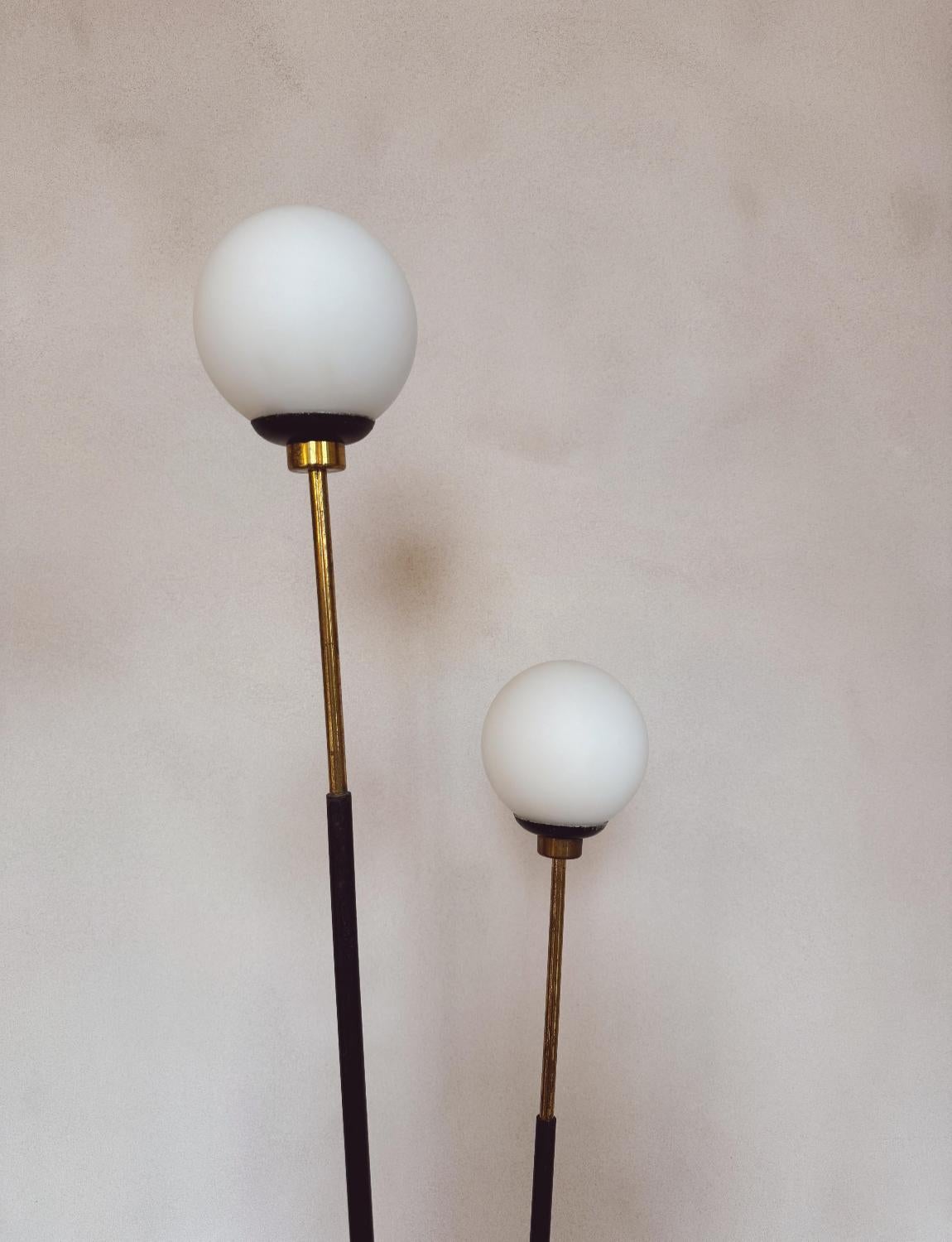 A beautiful 1960s Stilux floor lamp. Two beautiful opaque Italian glass balls fit atop brass fittings. The 165cm tall floor light has very heavy metal base making this a very sturdy piece. The cables have been restored and the light is in good
