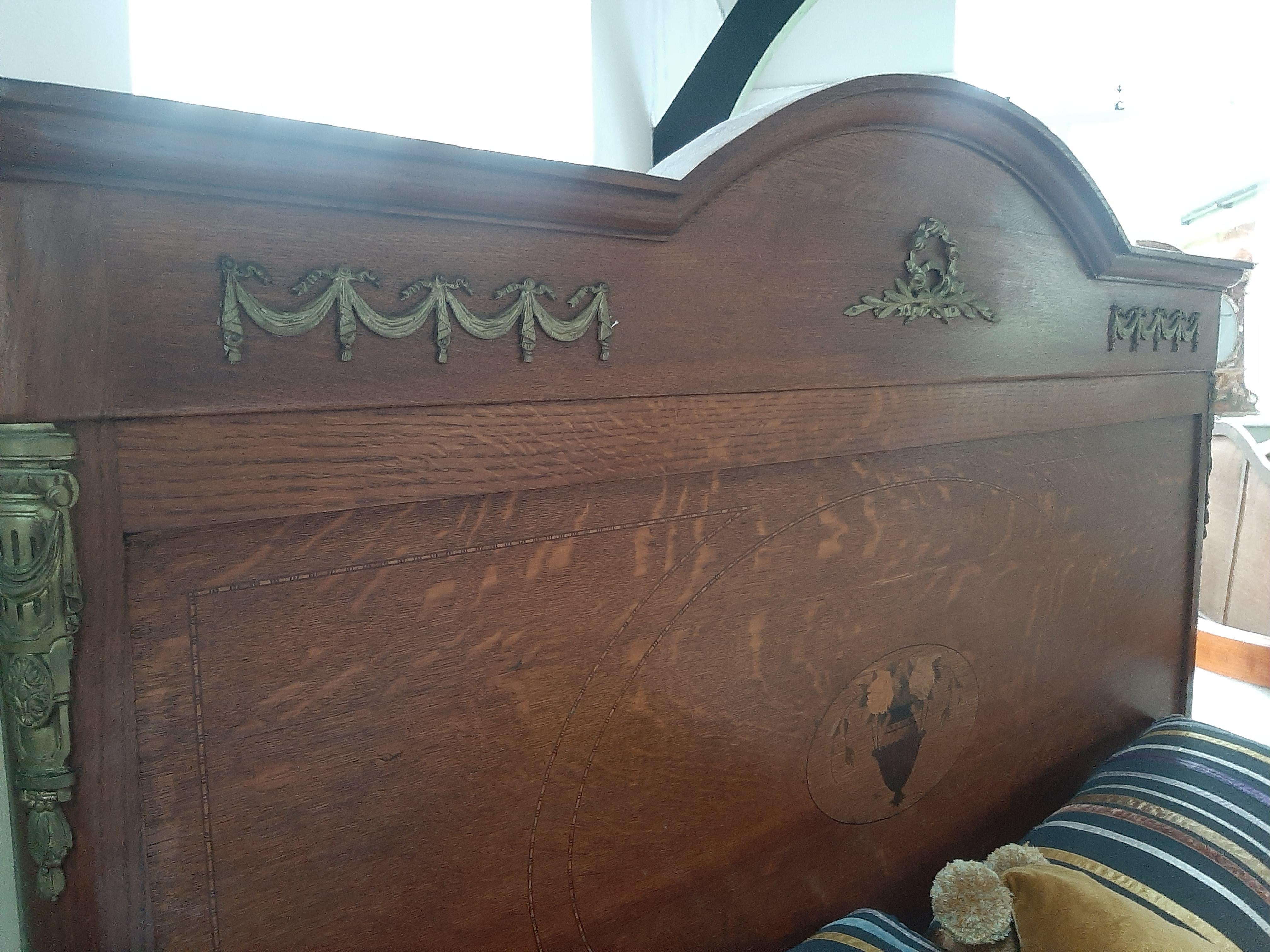 antique twin bed with curved footboard