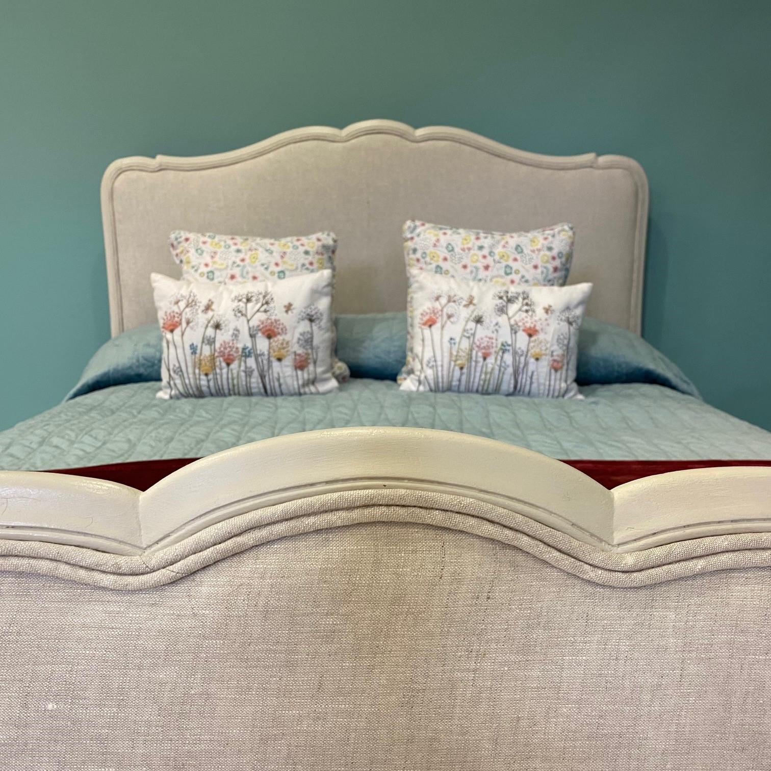 This charming French Antique double (4’6) upholstered bedframe has been newly upholstered in a neutral linen fabric. The frame has been finished with double piping in the same fabric to compliment the painted frame. the bed comes complete with a new