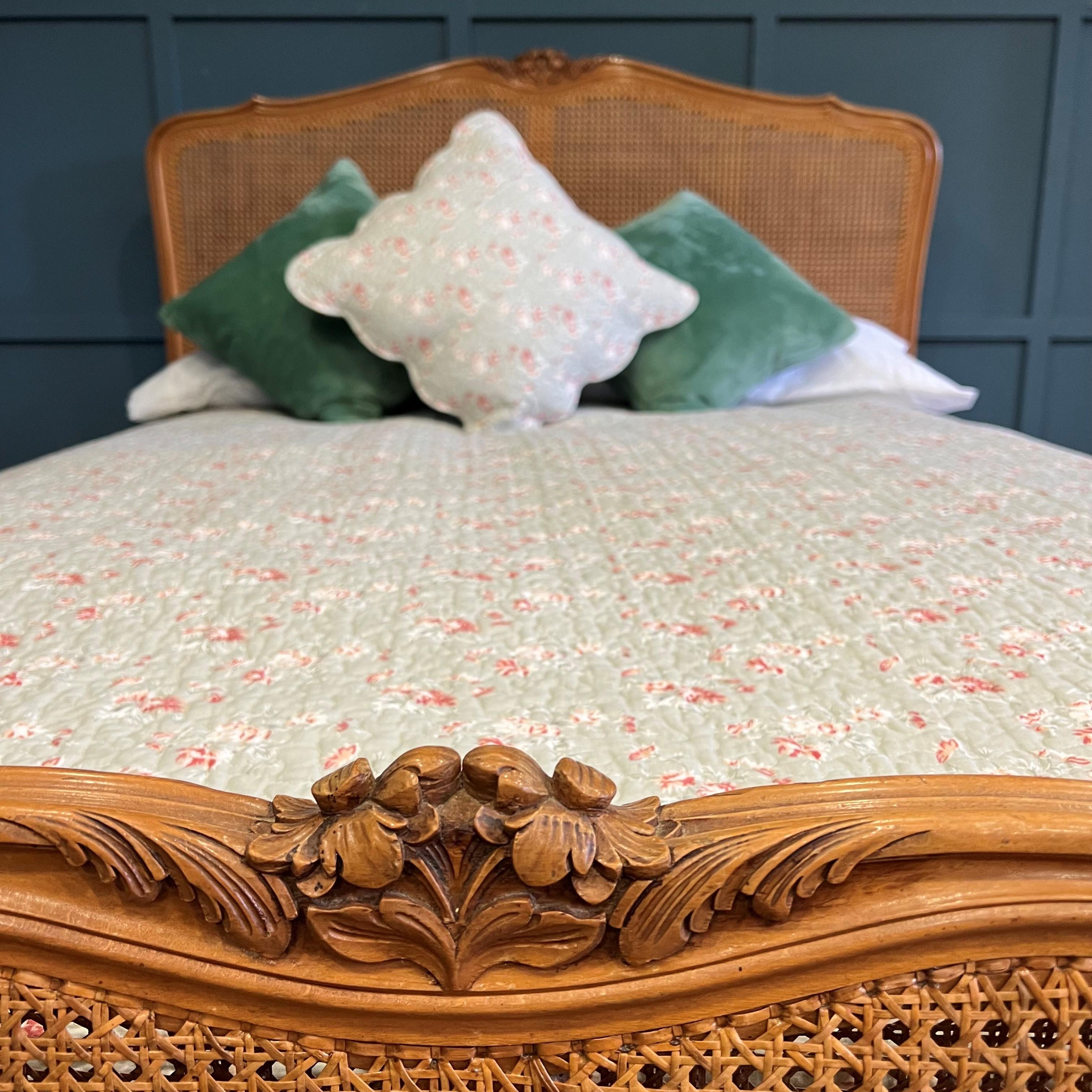 A simple old French caned bed with a curved foot end (demi corbeille). Double (4’6) King size (5’)The frame is made from Beech and has a light colour to the wood. The cane is in excellent condition. Circa 1900. The foot end is fairly low so will not