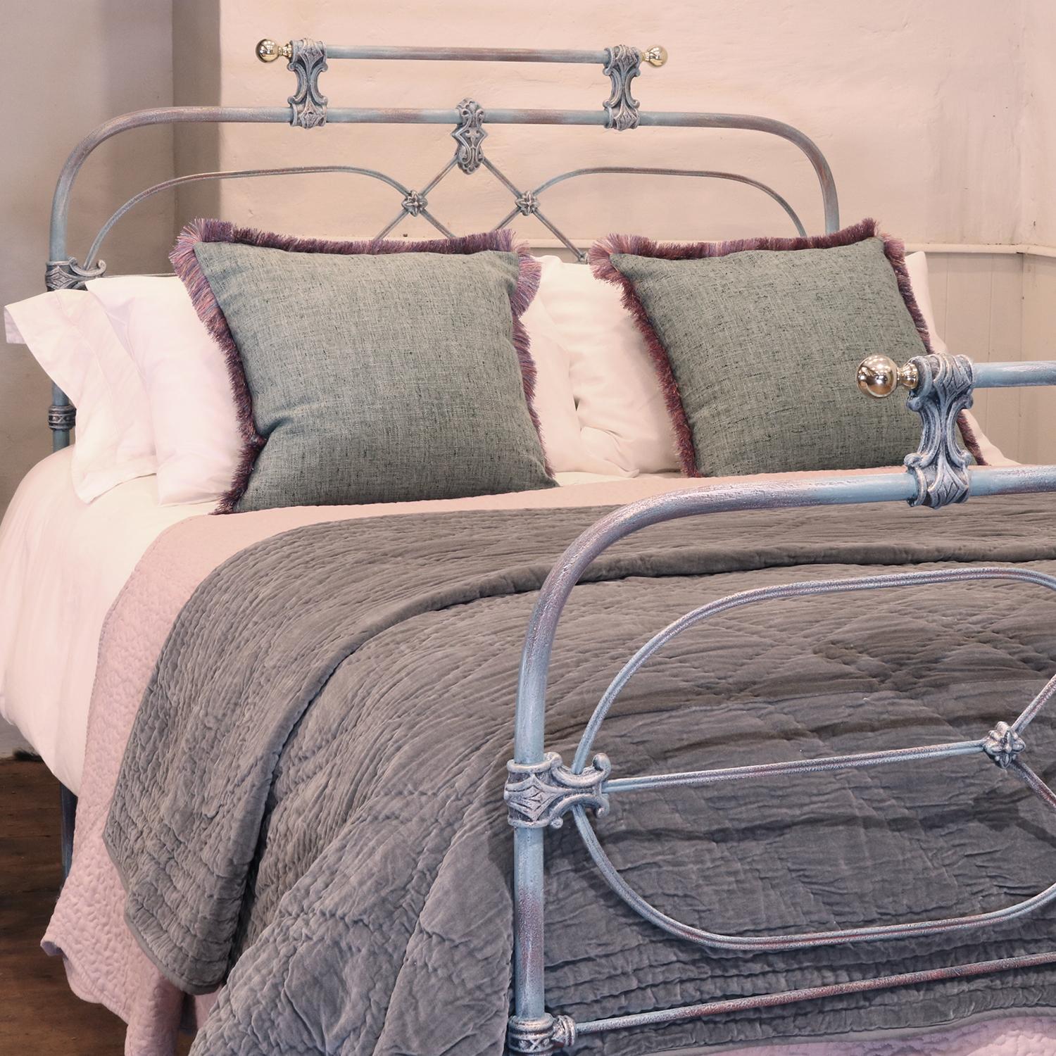 Cast iron antique bed, finished in blue verdigris with decorative castings, gallery rail and brass knobs.

This bed accepts a double size 4ft 6in wide (54 inch or 135cm) base and mattress. 

The price includes a FIRM standard bed base to support