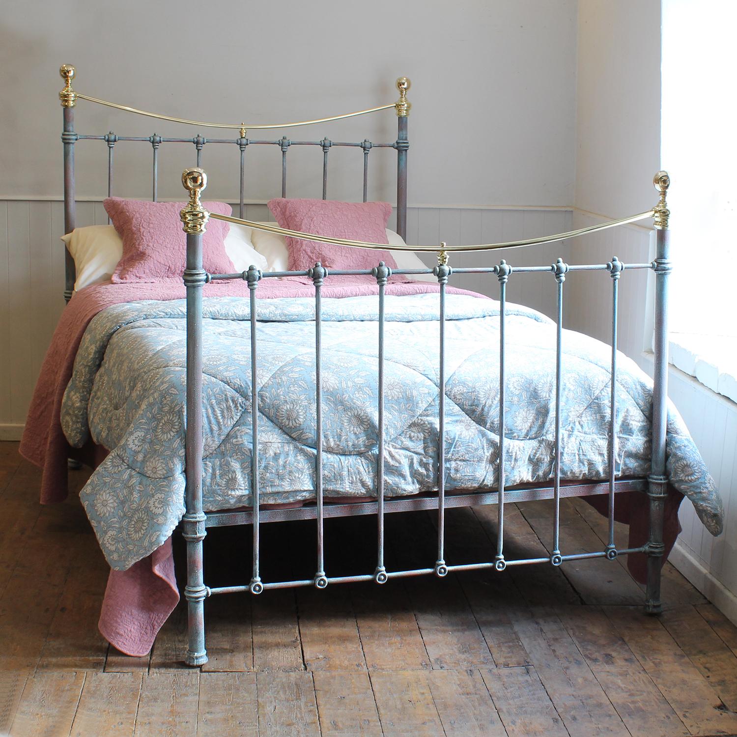 Late Victorian antique brass and iron bed finished in blue verdigris, with curved brass top rail and round knobs. 

This bed accepts a double size 4ft 6in wide (54 inch or 135cm) base and mattress.

The price includes a firm solid shallow bed base