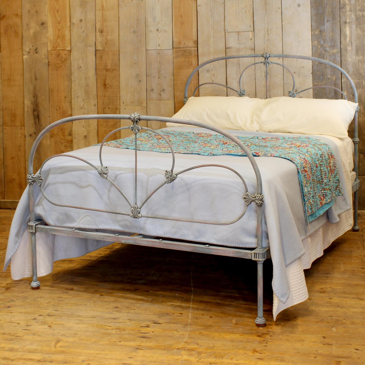 A Mid-Victorian antique brass and iron bed finished in hand paint blue verdigris, with decorative castings and hoop design.

This bed accepts a double size 4ft 6in wide (54 inch or 135cm) base and mattress.

The price includes a firm solid shallow