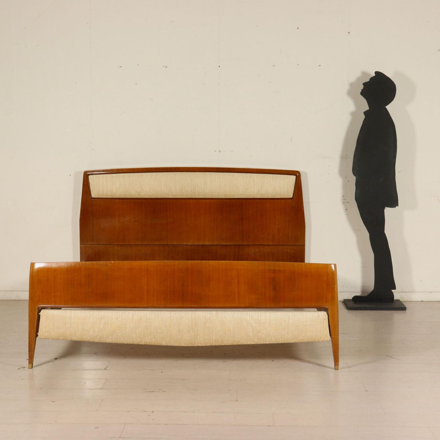 A double bed designed for Consorzio Esposizione Mobili Cantu', mahogany veneer, fabric upholstery, brass ferrules. Manufactured in Cantu', 1950s.