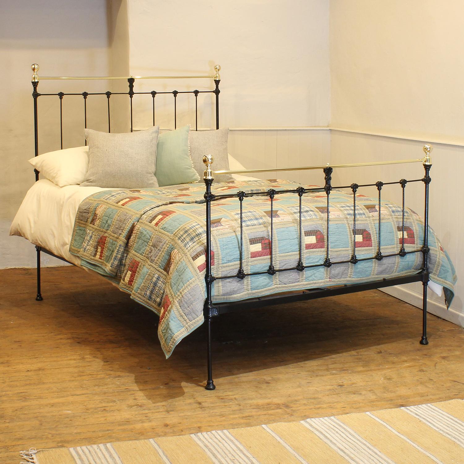 Victorian brass and cast iron bedstead finished in black with straight brass top rails and decorative castings.

This bed accepts a double size 4ft 6in wide (54 inch or 135cm) base and mattress. 

The price includes a firm standard bed base to
